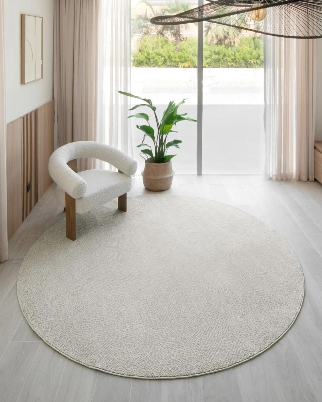 Marco Sandy Round carpet in beige, shown in a lifestyle front view