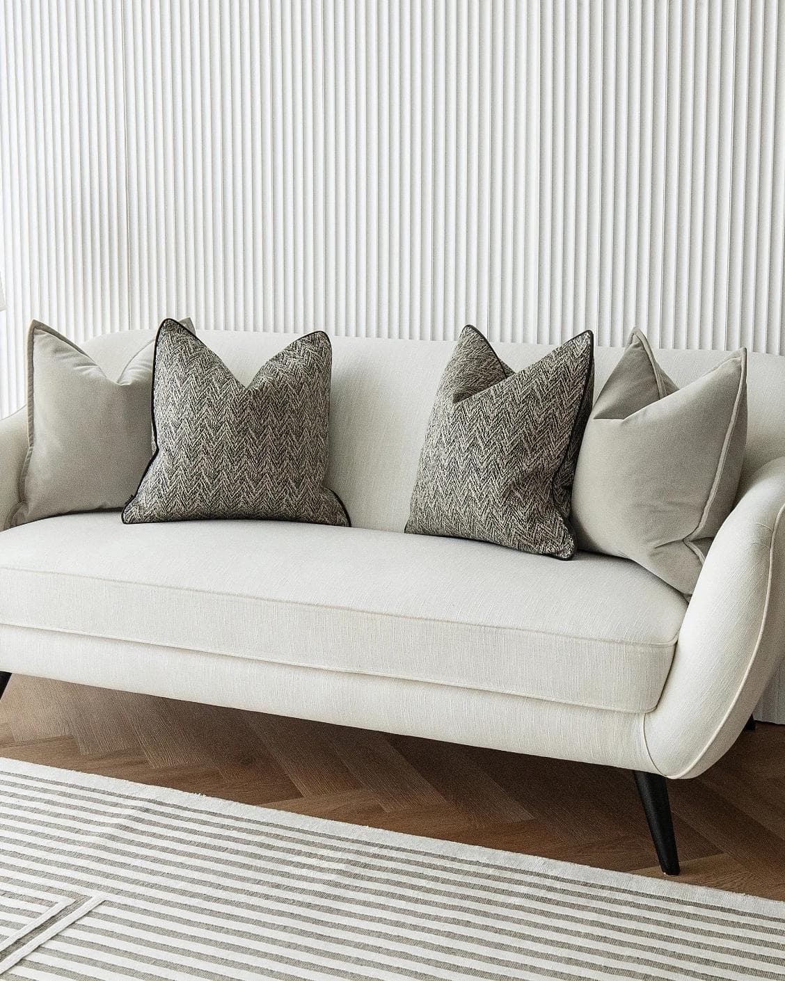 Marilee Bundle cushion in brown, grey and black, shown in a lifestyle right view as image 2