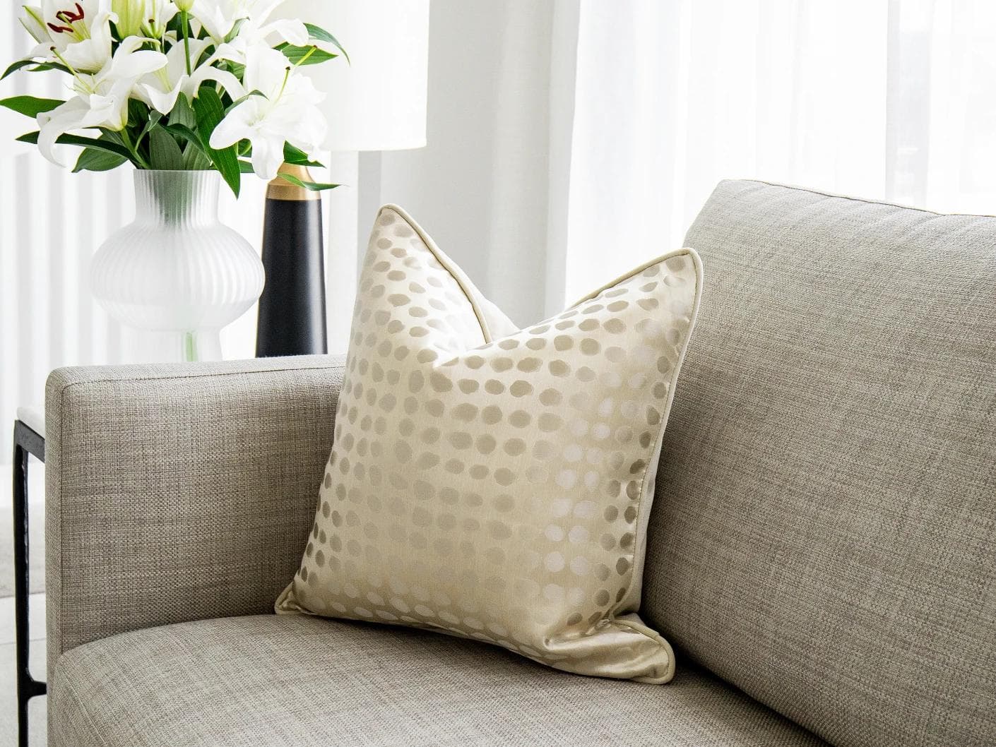 Marissa Bianca cushion in beige and silver, shown in a lifestyle front view as image 2