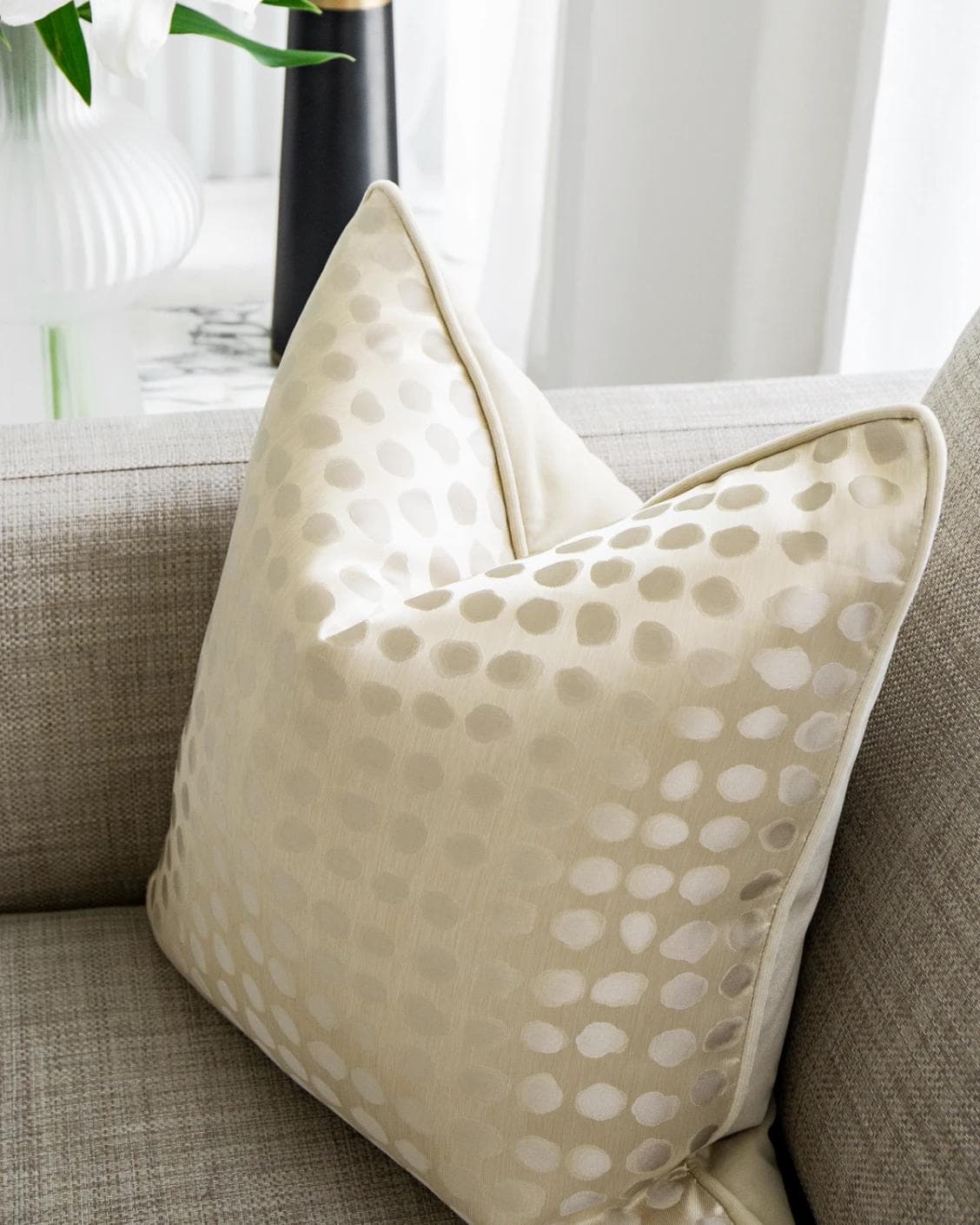 Marissa Bianca cushion in beige and silver, shown in a lifestyle top view as image 5