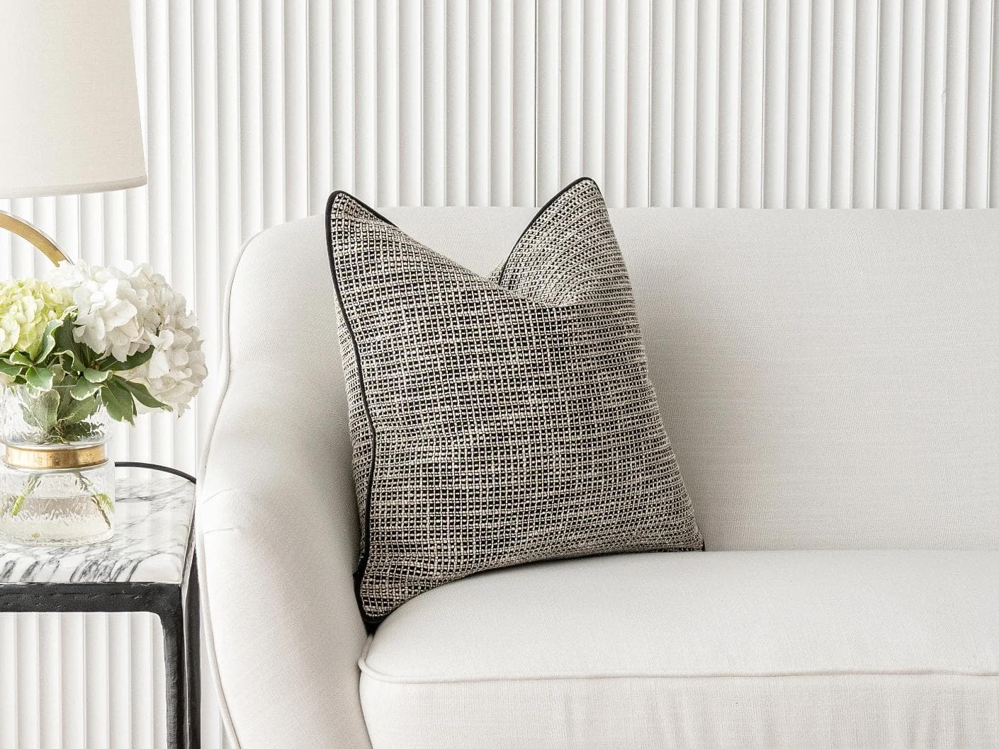 Marlee Steele cushion in black, shown in a lifestyle front view as image 4