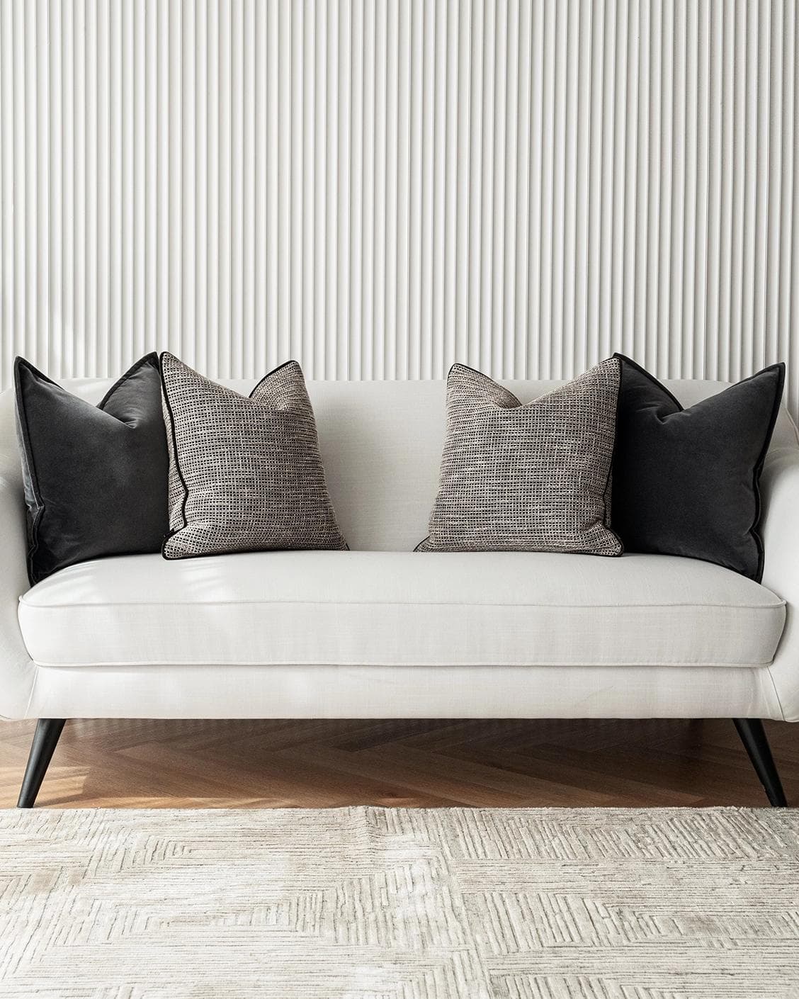 Martina Bundle cushion in grey and black, shown in a lifestyle front view as image 4