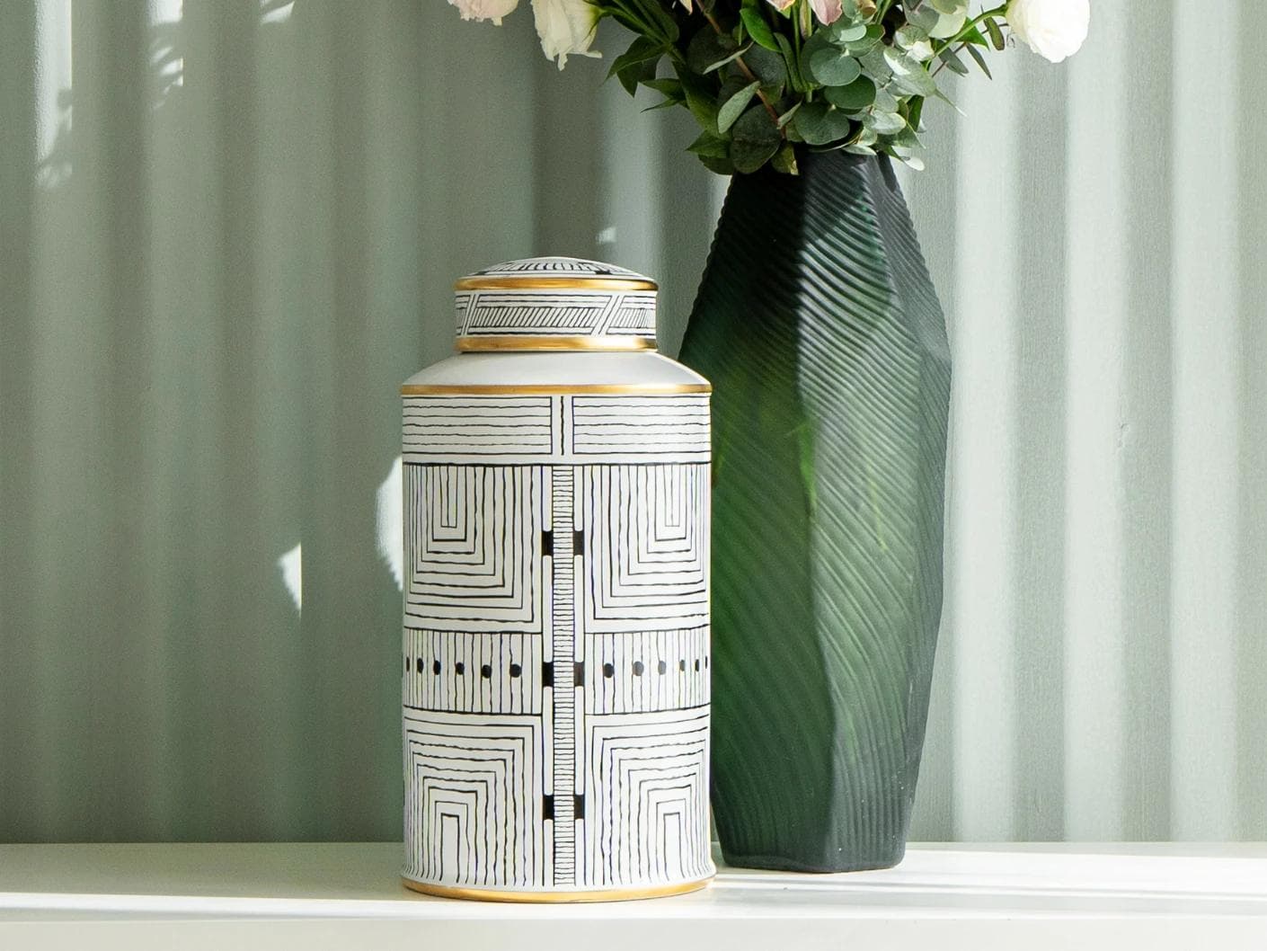 Maze Arneson canisters in black and white, shown in a lifestyle front view as image 8