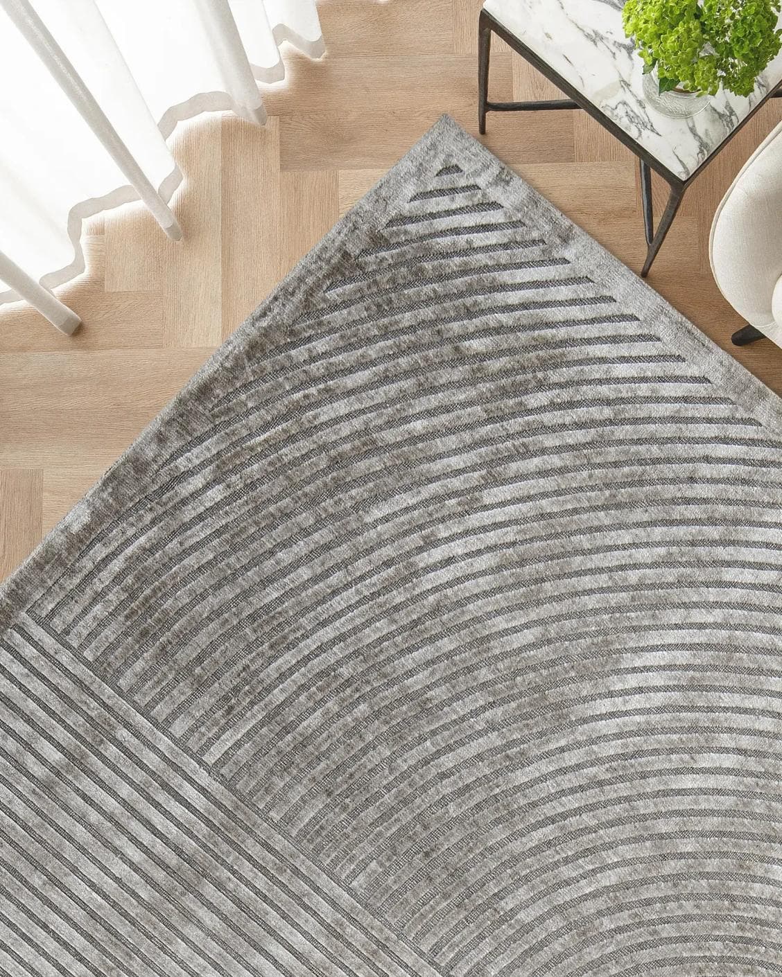 Maze Ashton carpet in grey, shown in a lifestyle top view as image 2