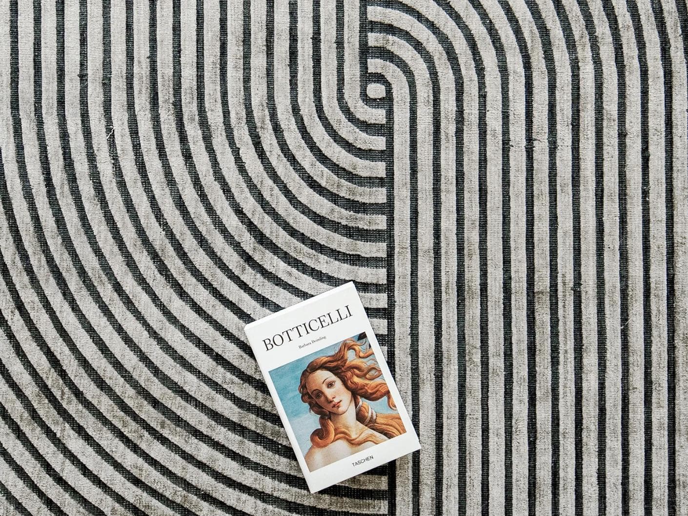 Maze Ebony carpet in grey and charcoal, shown in a lifestyle top view as image 6