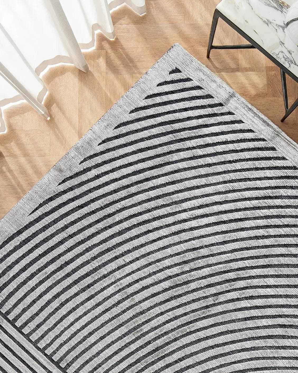 Maze Ebony carpet in grey and charcoal, shown in a lifestyle top view as image 2