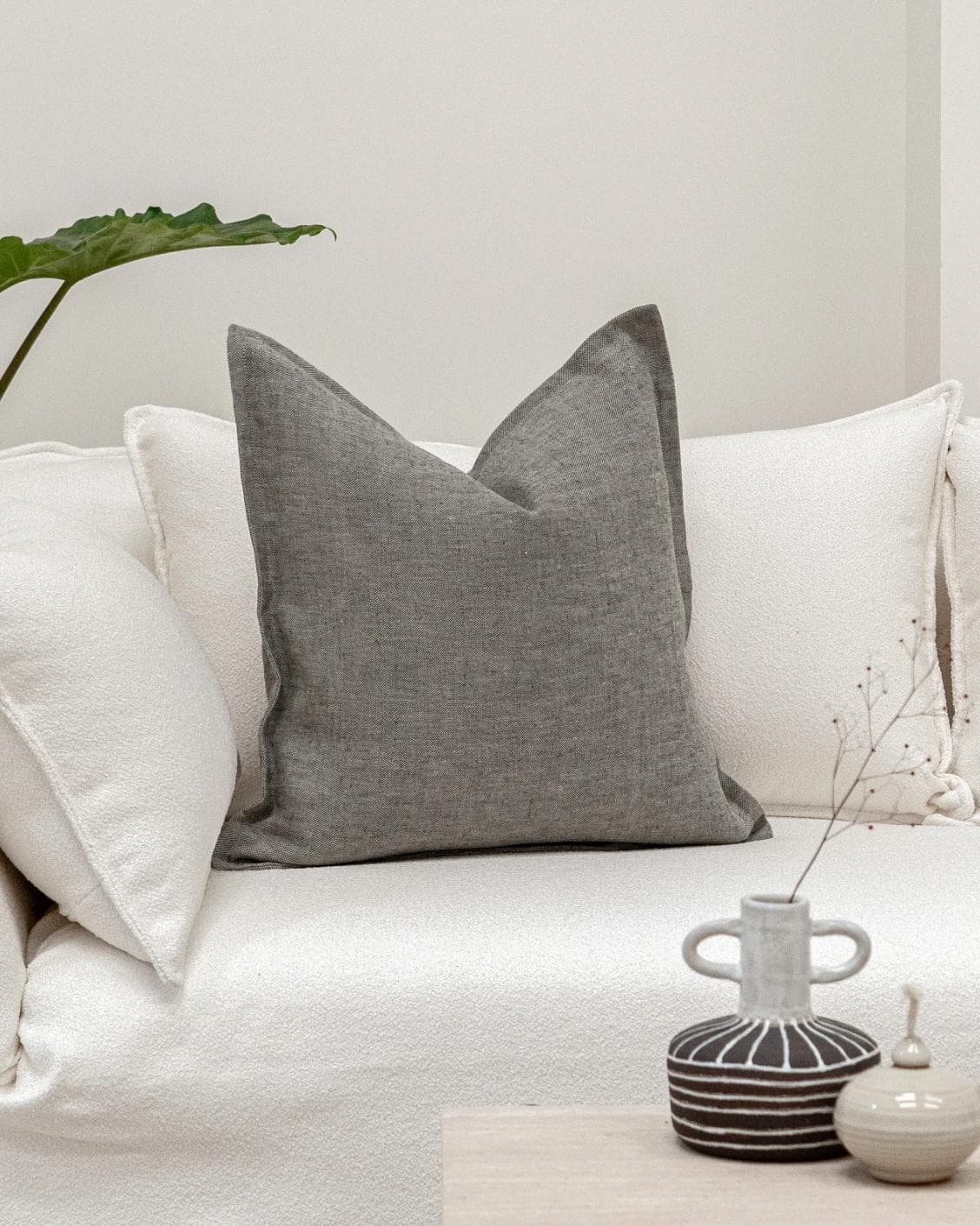 Mel Ash cushion in grey, shown in a lifestyle front view as image 4