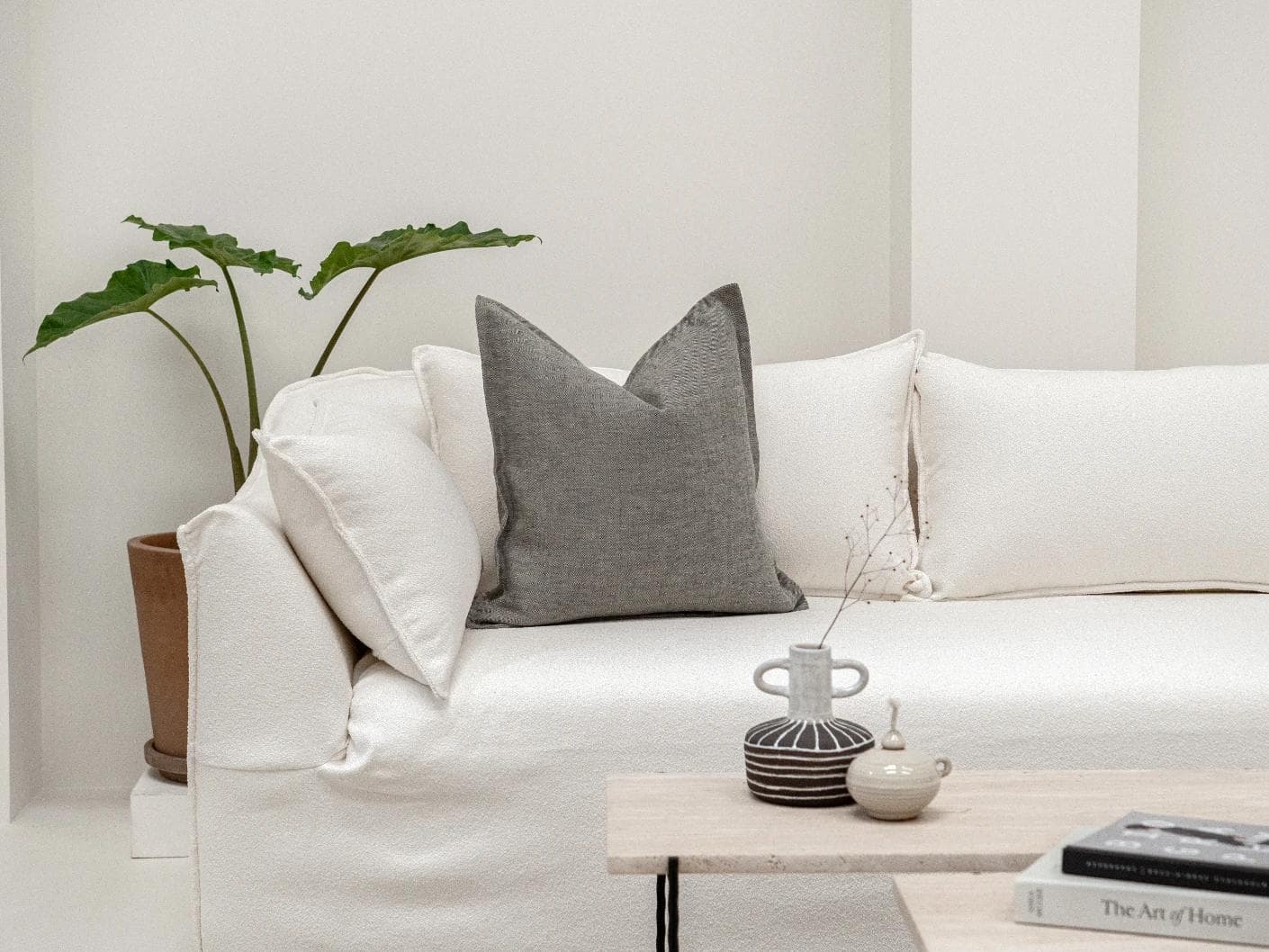 Mel Ash cushion in grey, shown in a lifestyle front view as image 4