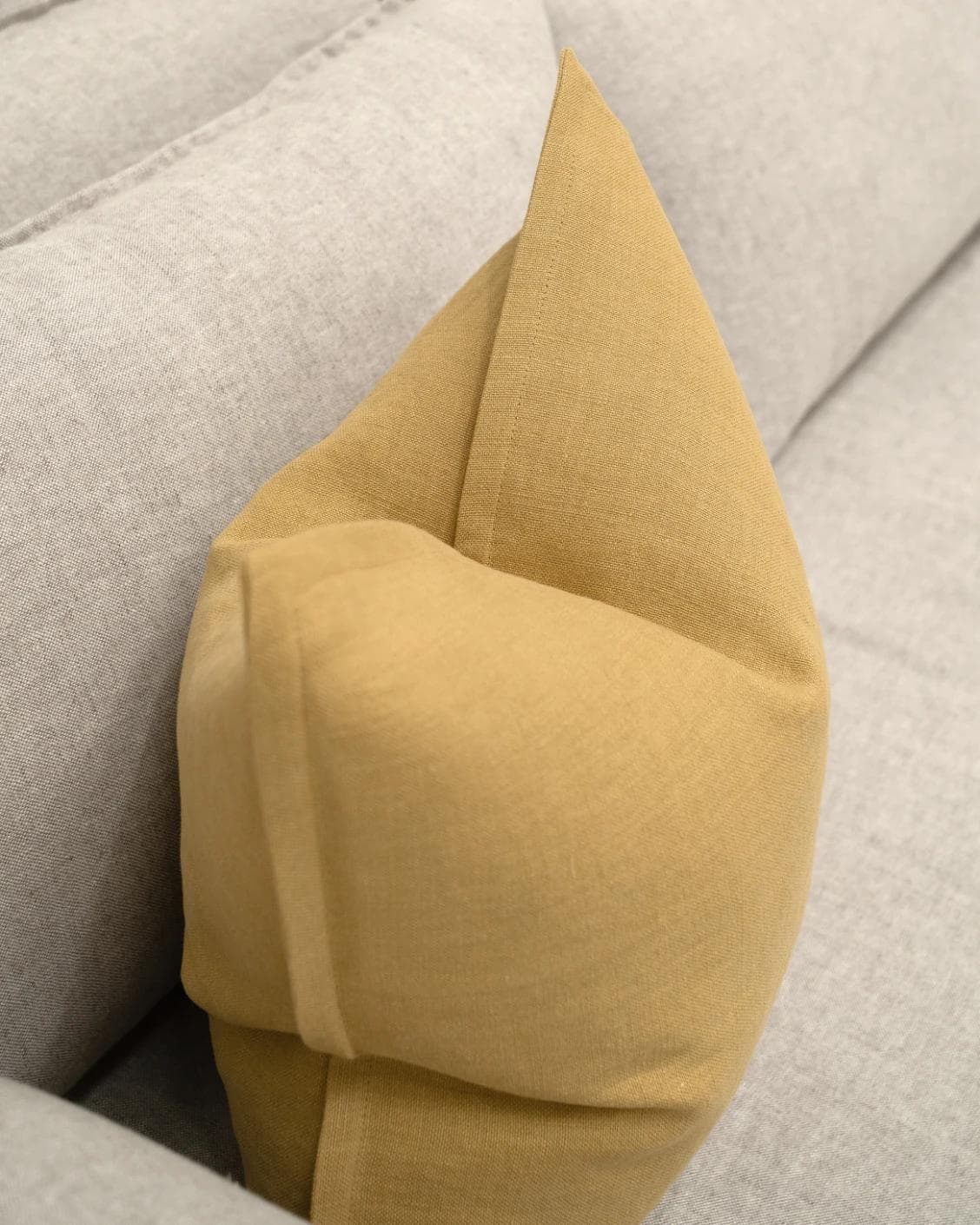 Mel Barrymore cushion in yellow, shown in a lifestyle top view as image 6