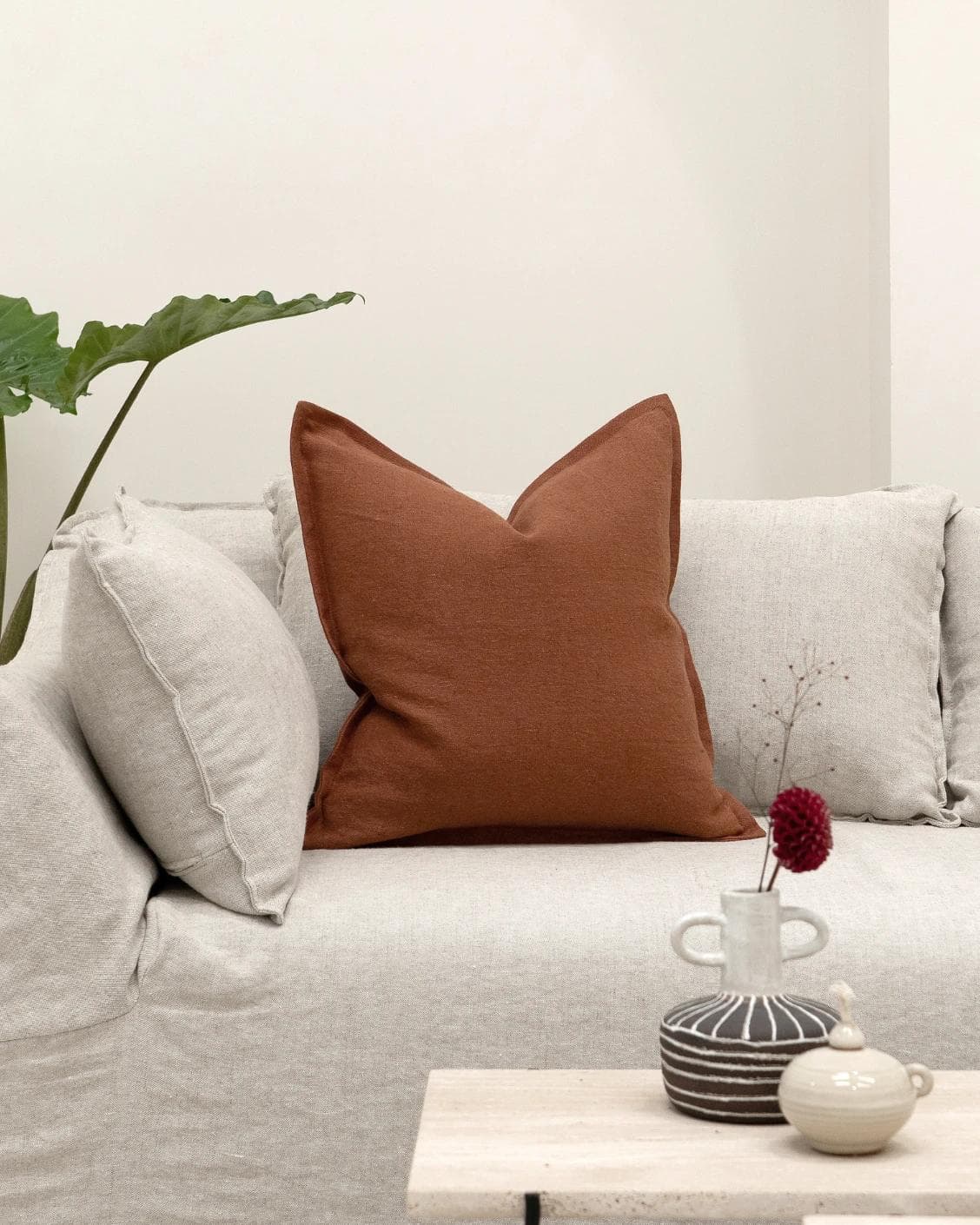 Mel Brick cushion in rust, shown in a lifestyle front view as image 4