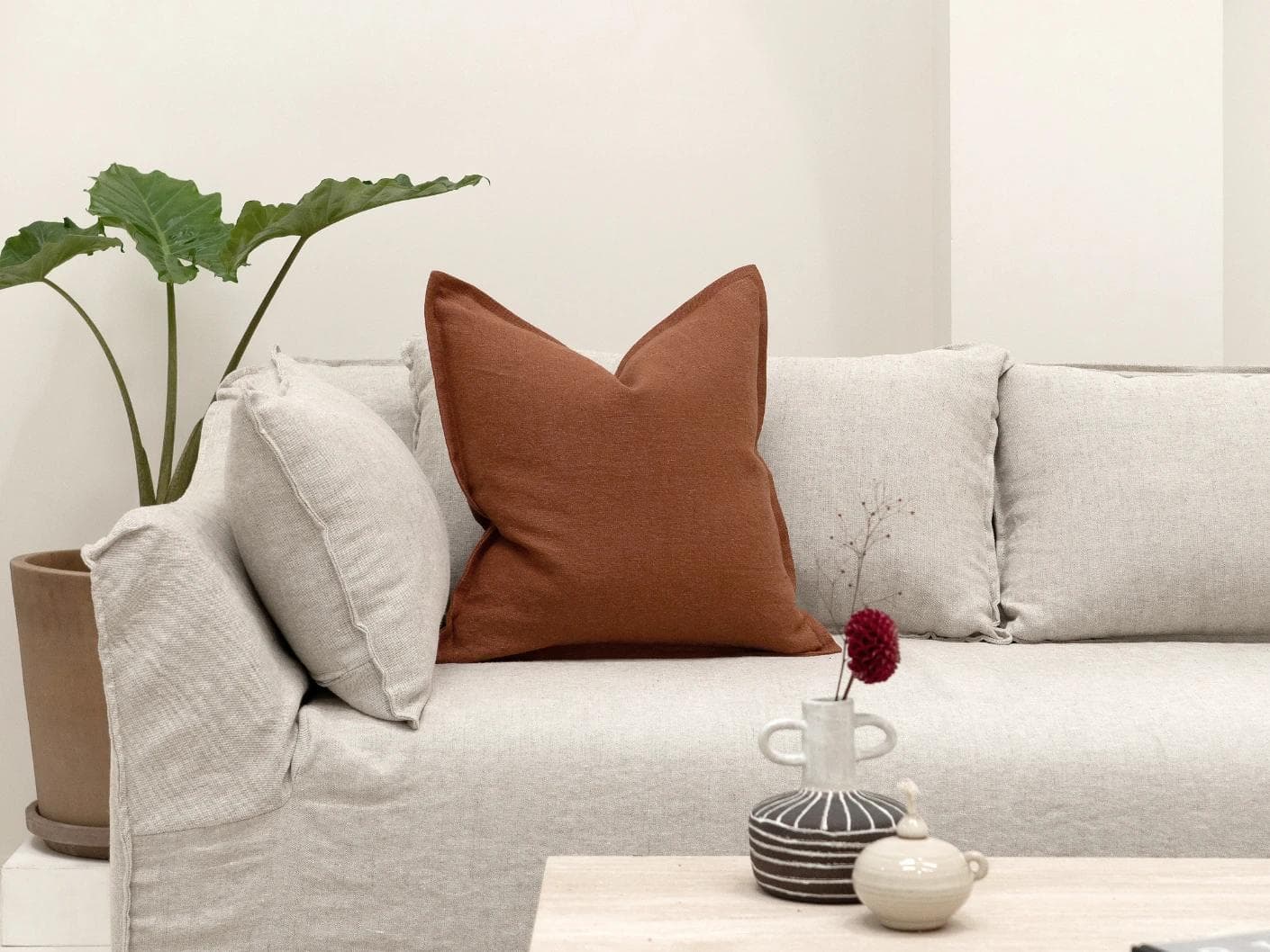 Mel Brick cushion in rust, shown in a lifestyle front view as image 4