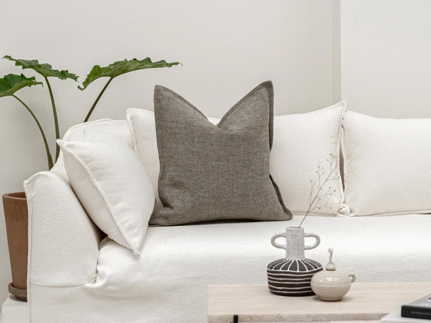 Mel Smoke cushion in linen, grey and charcoal, shown in a lifestyle front view as image 4