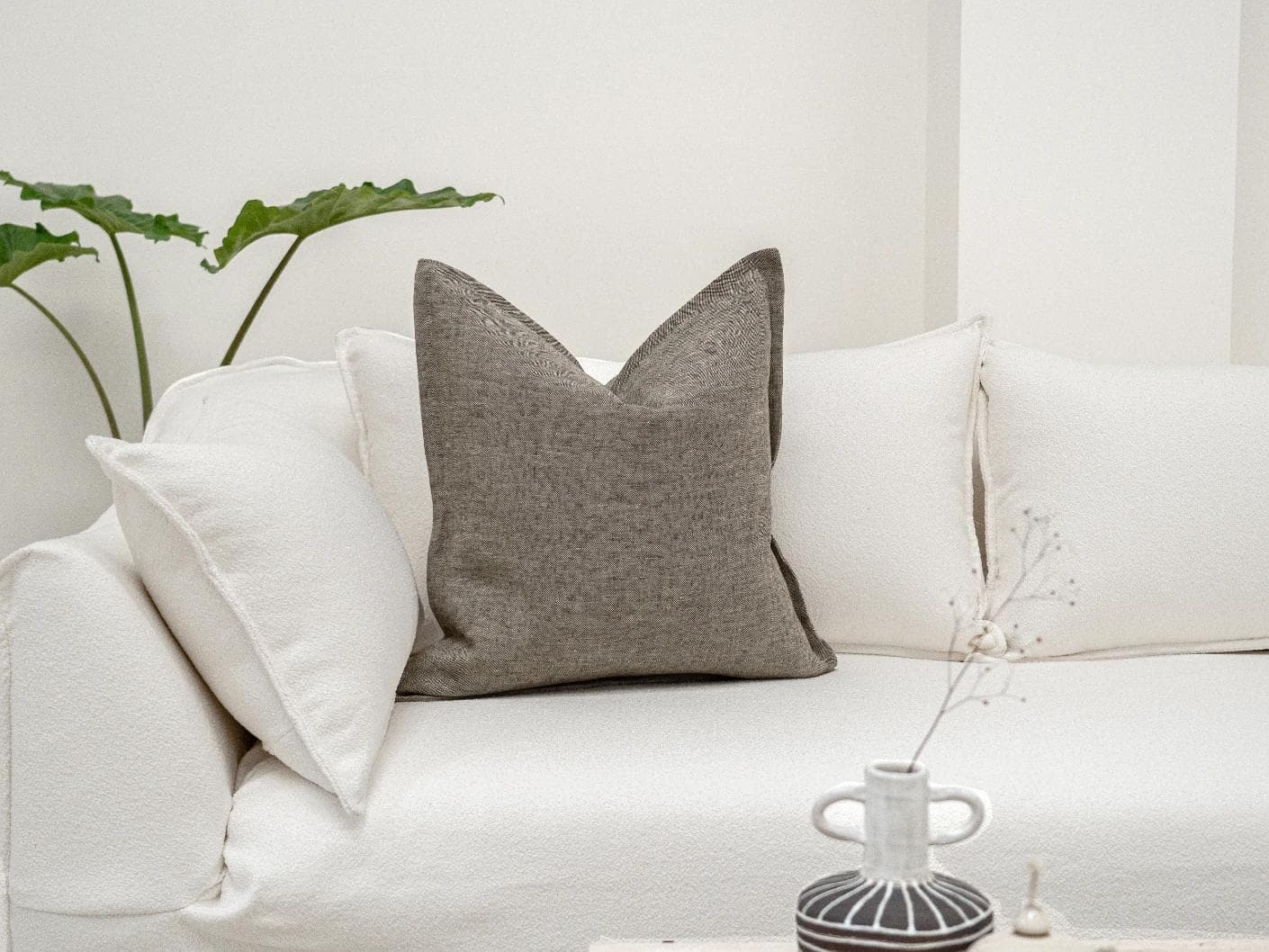 Mel Smoke cushion in linen, grey and charcoal, shown in a lifestyle front view as image 2