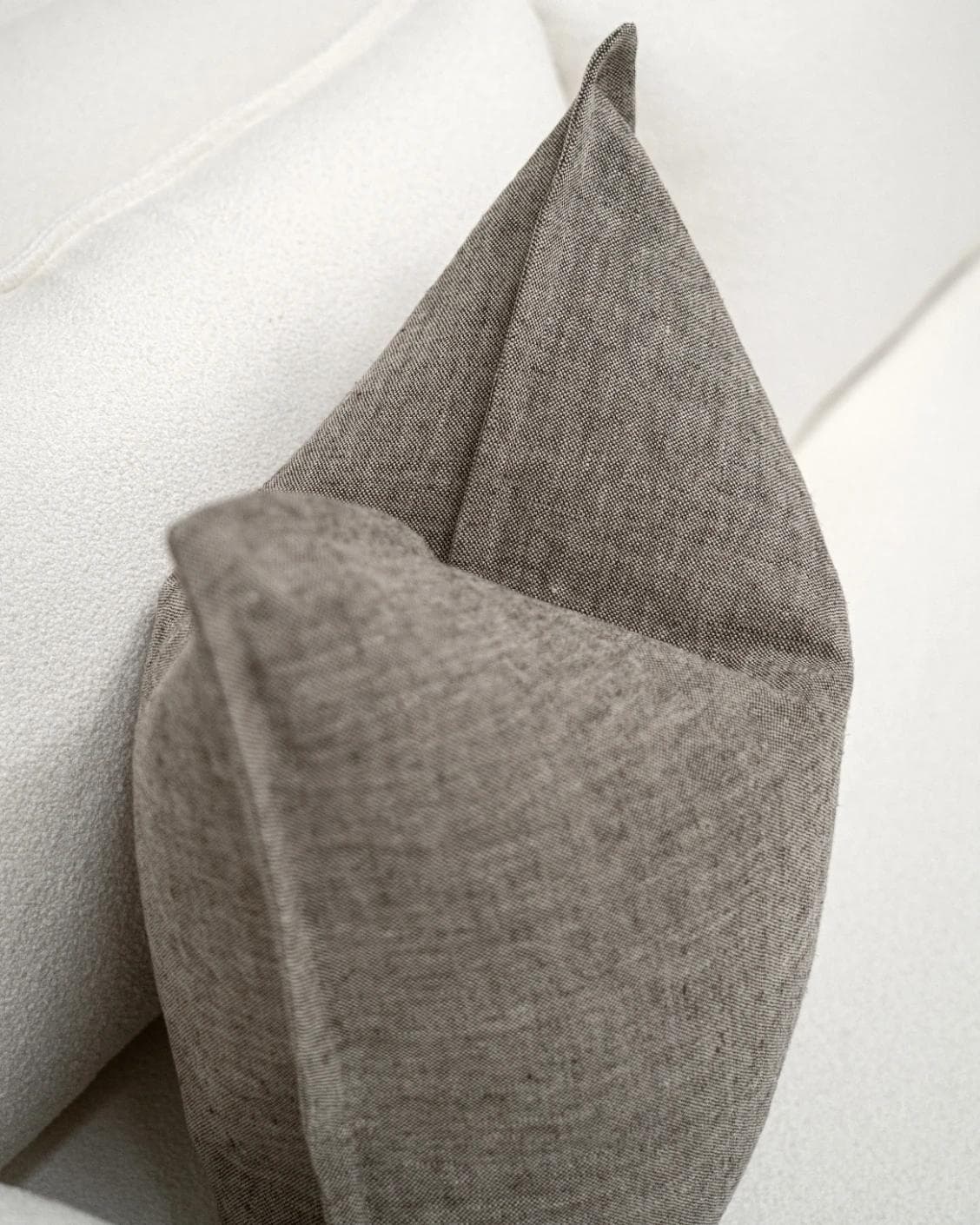 Mel Smoke cushion in linen, grey and charcoal, shown in a lifestyle top view as image 5