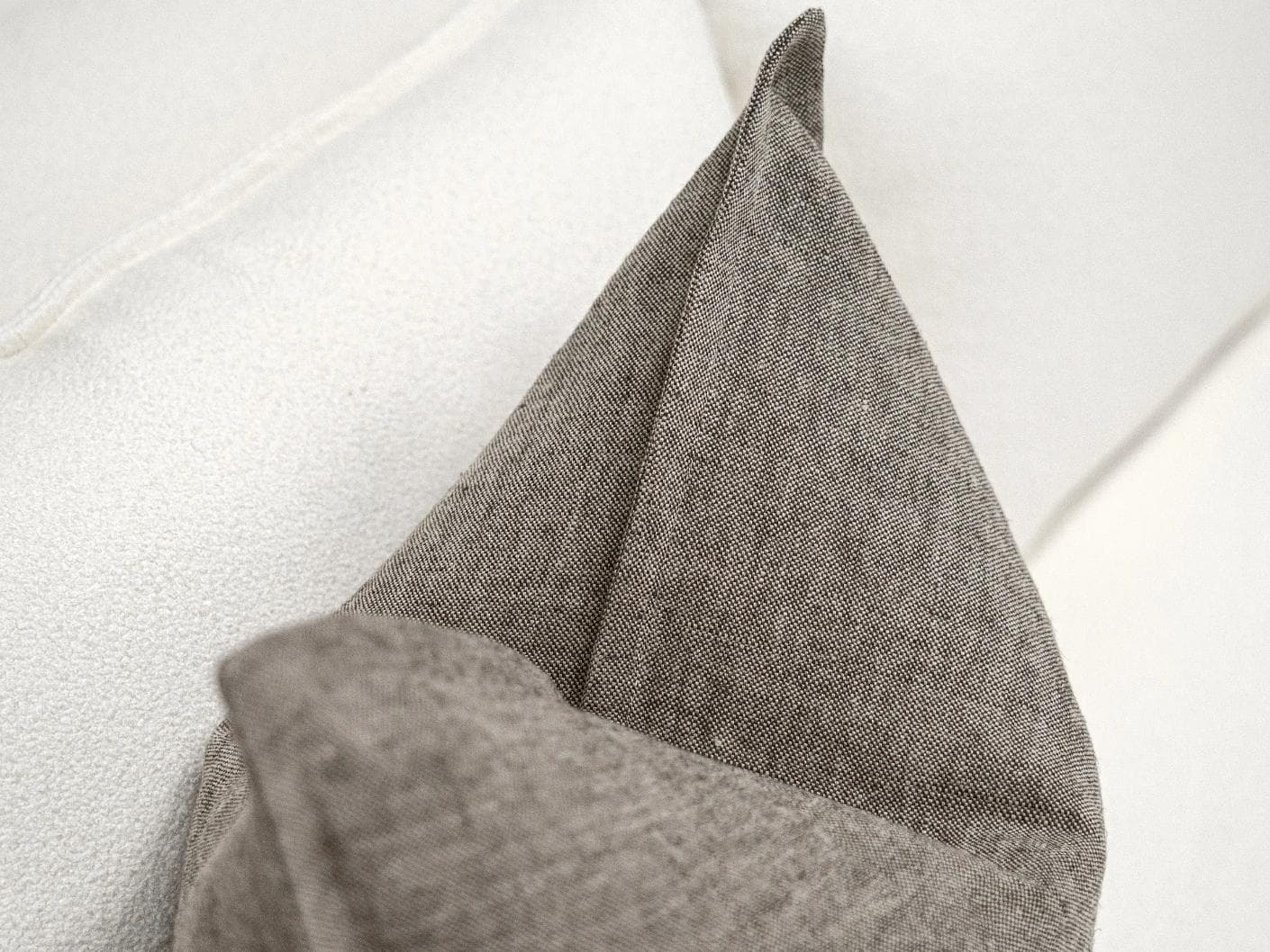 Mel Smoke cushion in linen, grey and charcoal, shown in a lifestyle top view as image 5