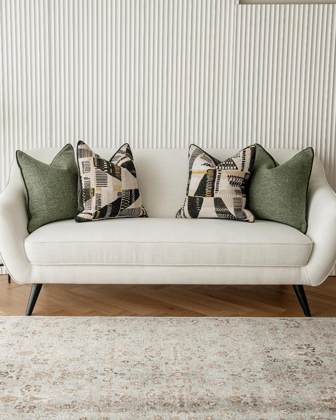 Melaina Bundle cushion in green, black and beige, shown in a lifestyle front view as image 4