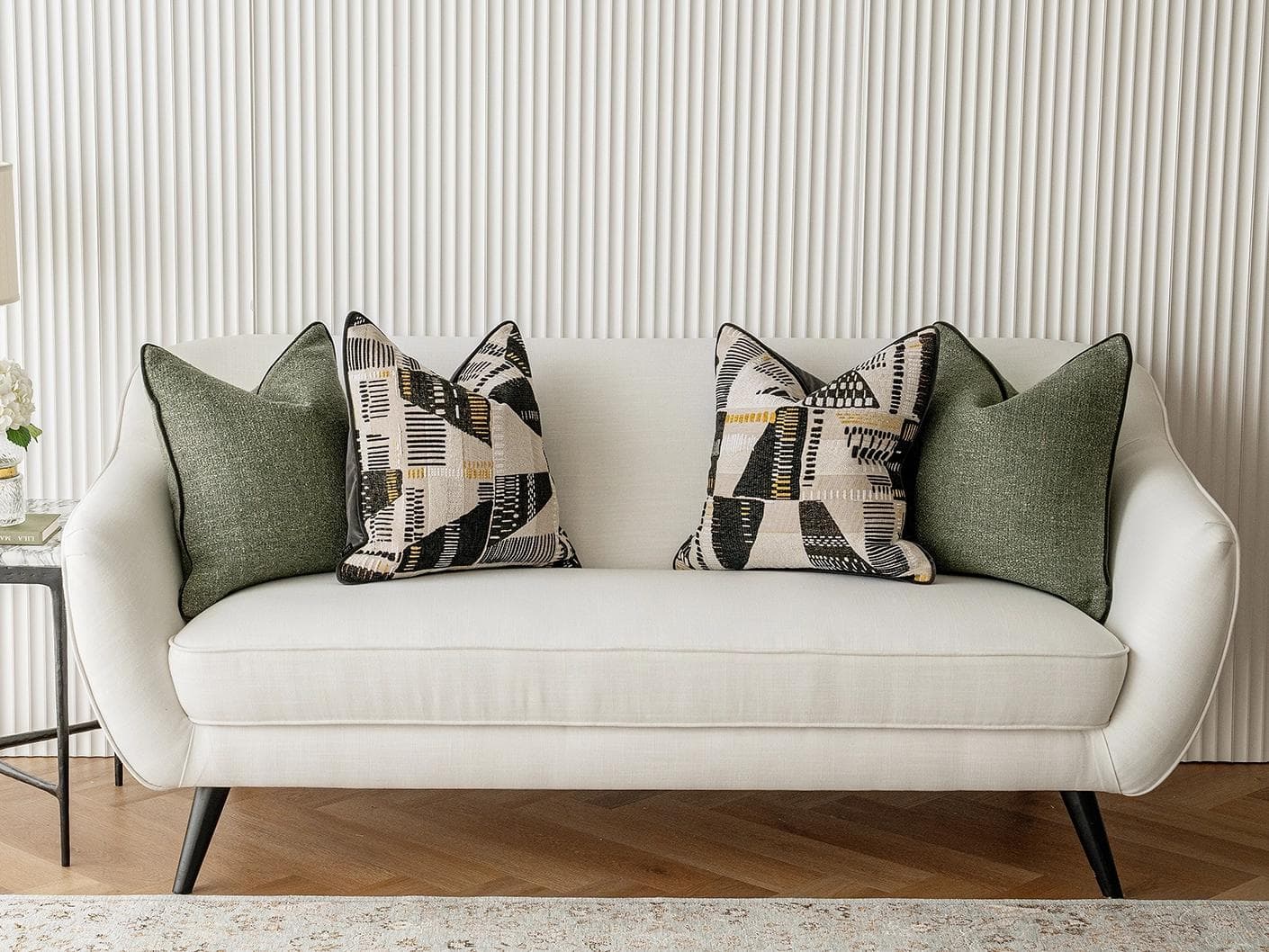 Melaina Bundle cushion in green, black and beige, shown in a lifestyle front view as image 4