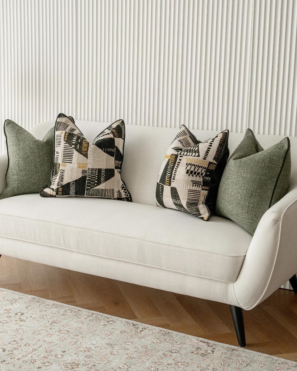 Melaina Bundle cushion in green, black and beige, shown in a lifestyle right view as image 2