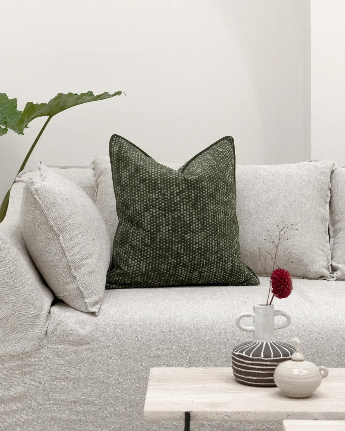 Mercy Sage cushion in green, shown in a lifestyle front view as image 4