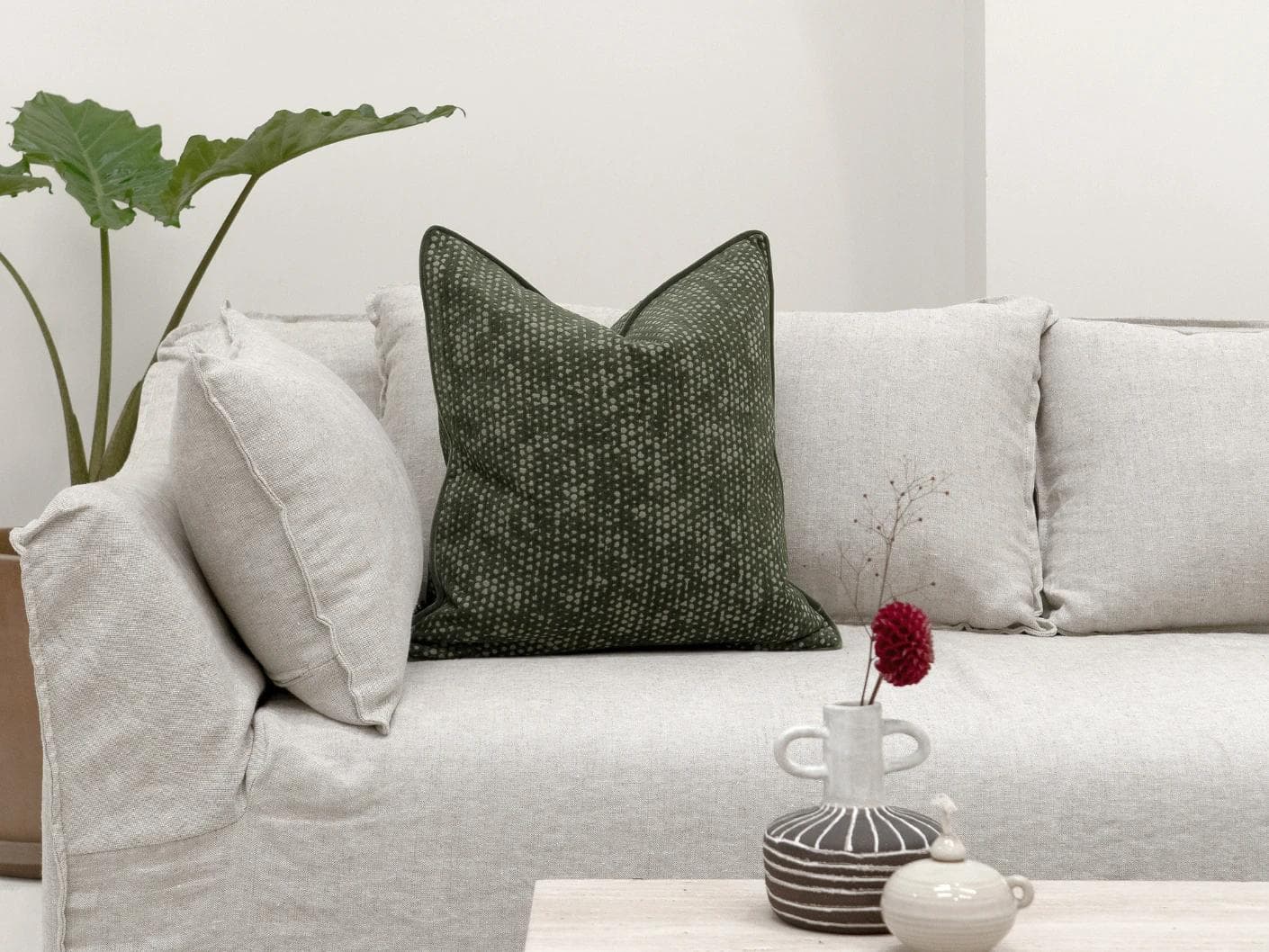 Mercy Sage cushion in green, shown in a lifestyle front view as image 4