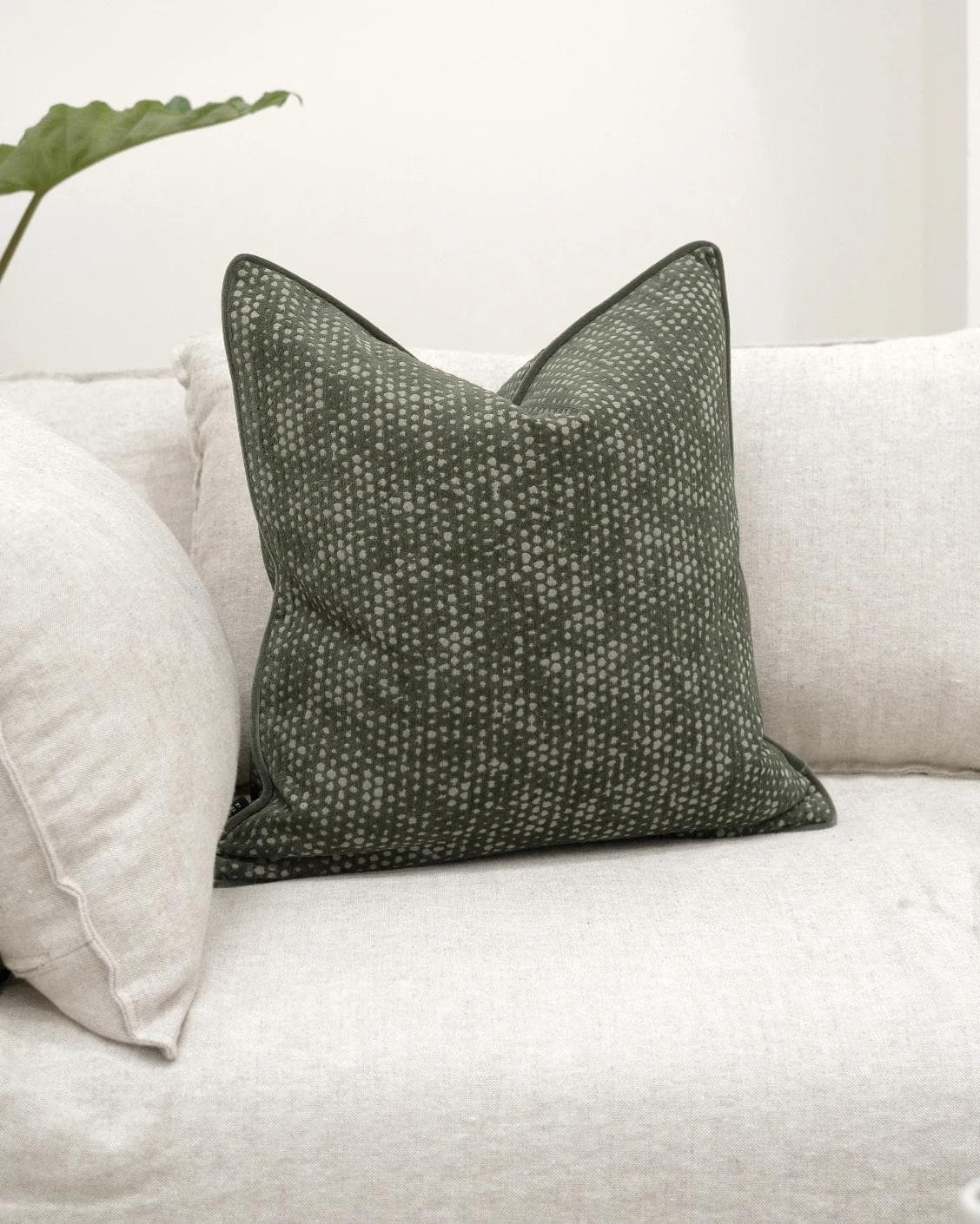 Mercy Sage cushion in green, shown in a lifestyle front view as image 2