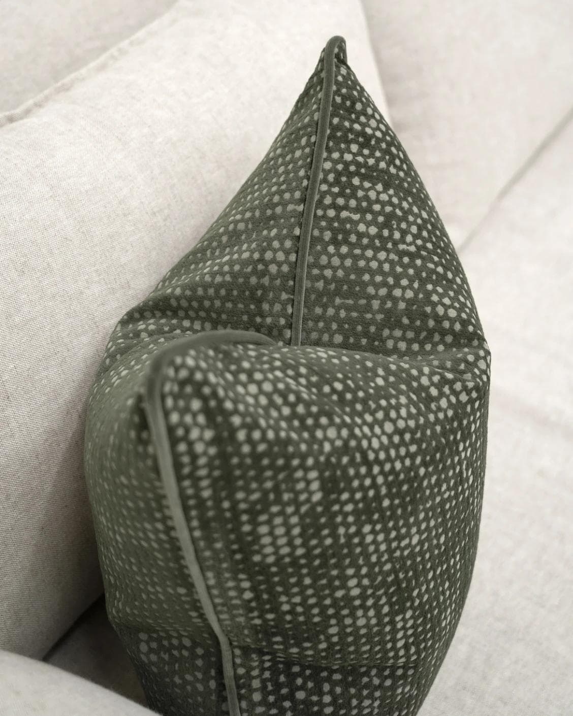 Mercy Sage cushion in green, shown in a lifestyle top view as image 5