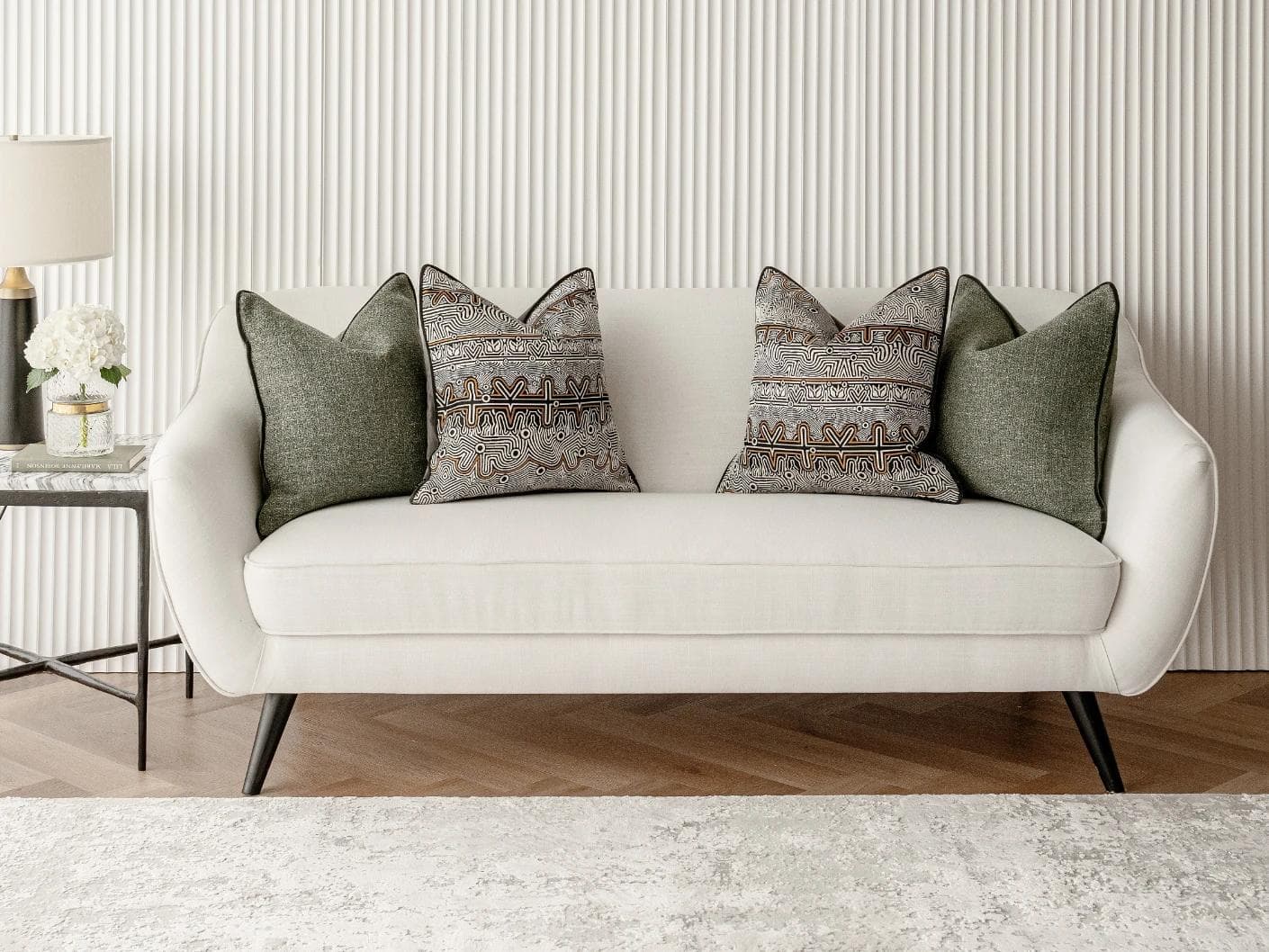 Mika Bundle cushion in black, silver and green, shown in a lifestyle front view as image 4