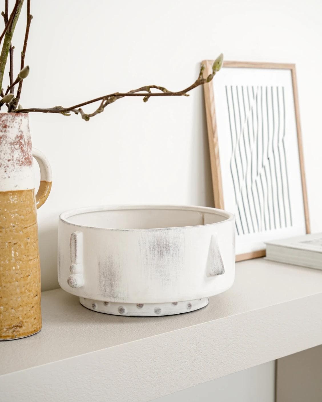 Misha Terra bowls in ivory and white, shown in a lifestyle left view as image 2
