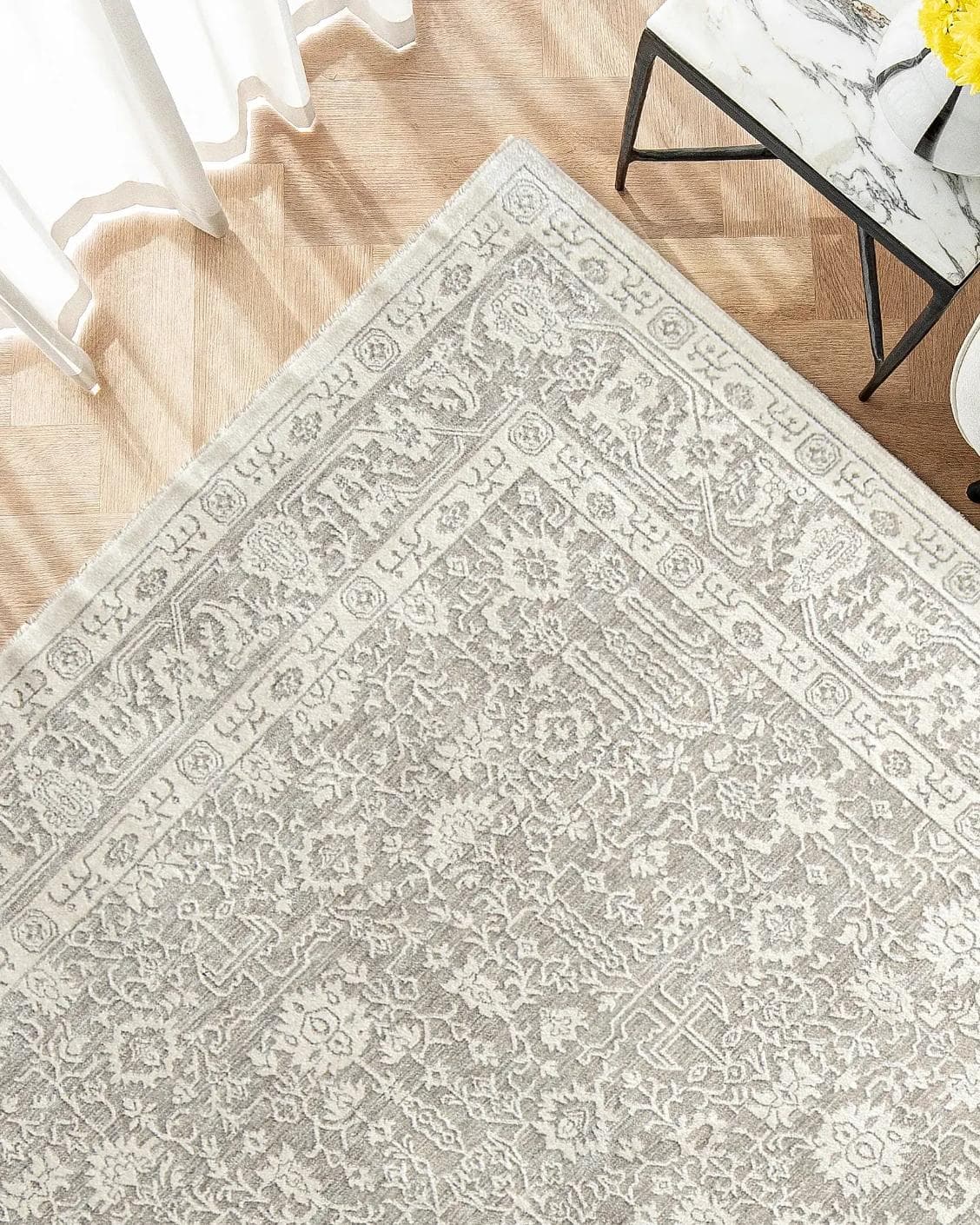 Natalia Sandy carpet in beige and grey, shown in a lifestyle top view as image 2