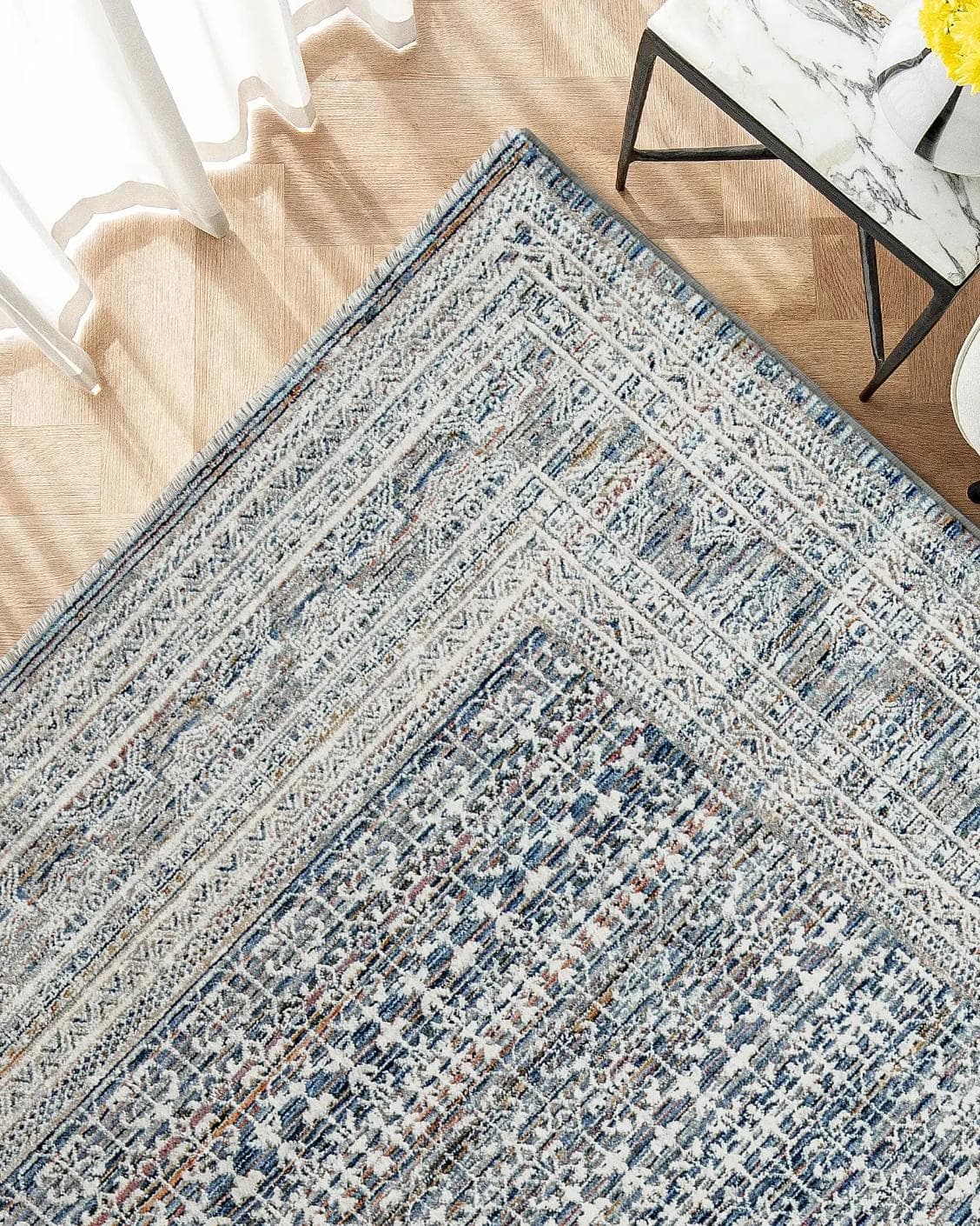 Natalia Sky carpet in blue, shown in a lifestyle top view as image 2