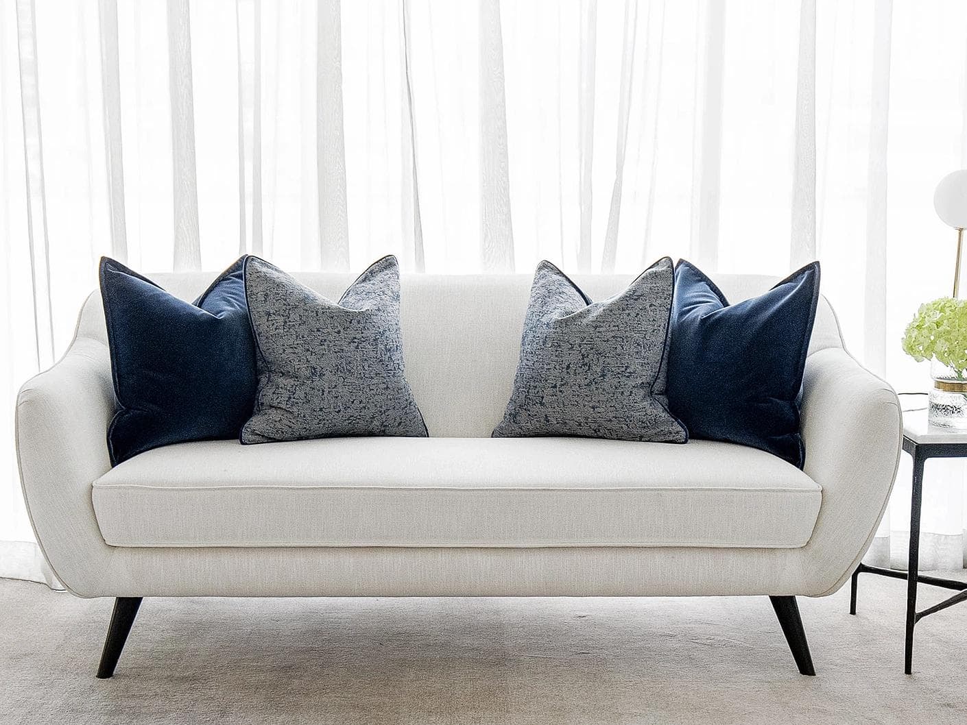 Clea Bundle cushion in navy, grey and royal blue, shown in a lifestyle front view as image 4