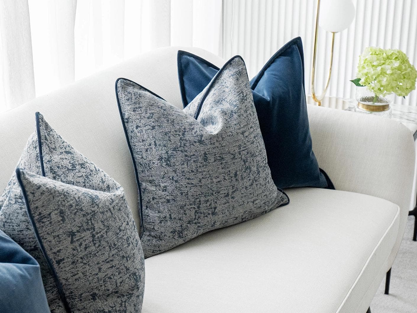 Clea Bundle cushion in navy, grey and royal blue, shown in a lifestyle left view as image 5