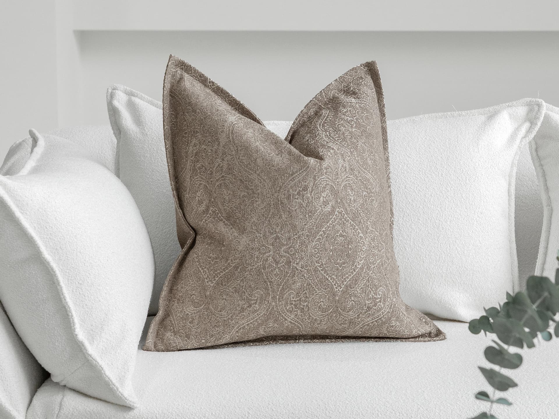 Nia Laurent cushion in taupe and grey, shown in a lifestyle as image 2