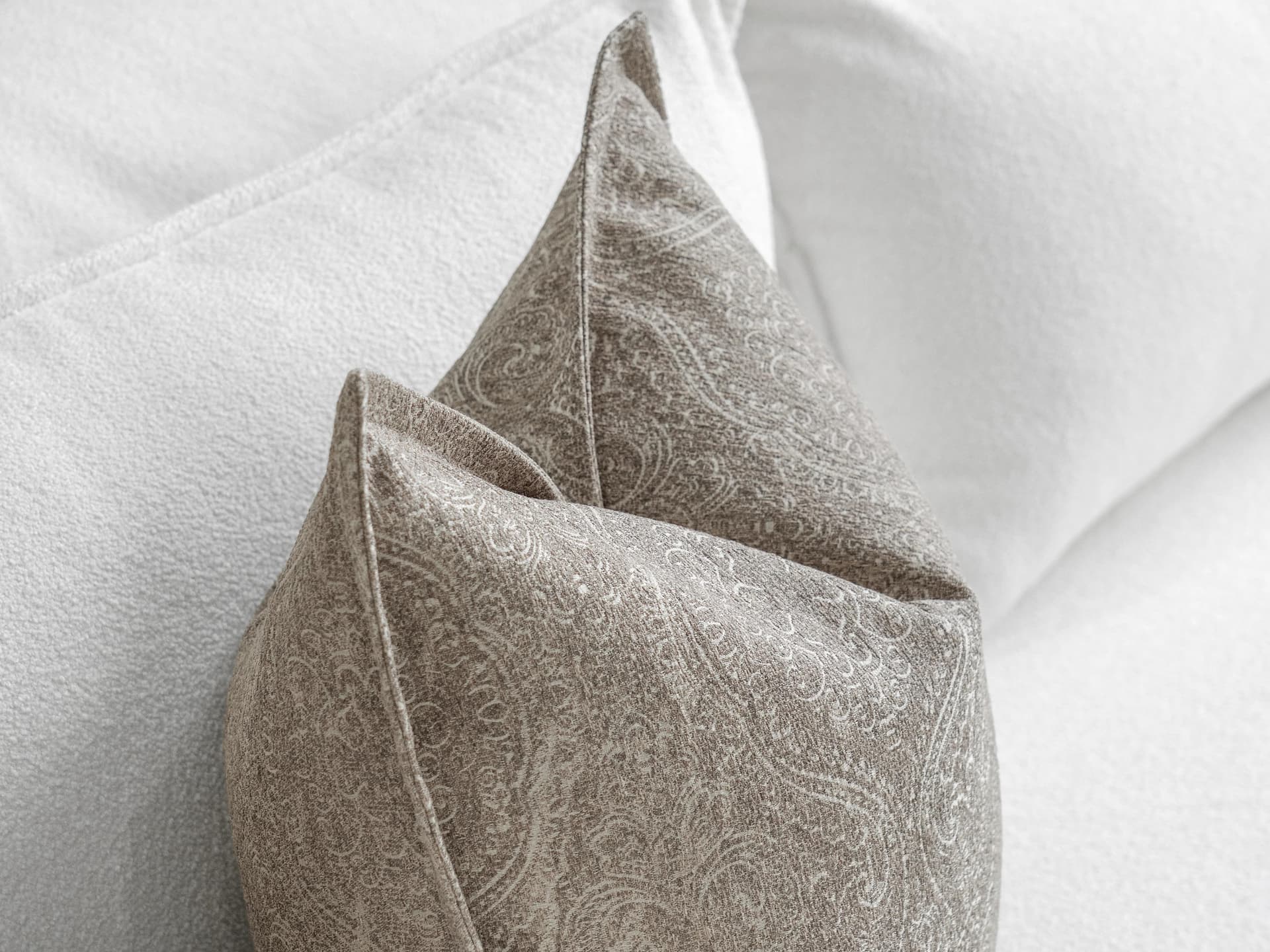 Nia Laurent cushion in taupe and grey, shown in a lifestyle top view as image 5