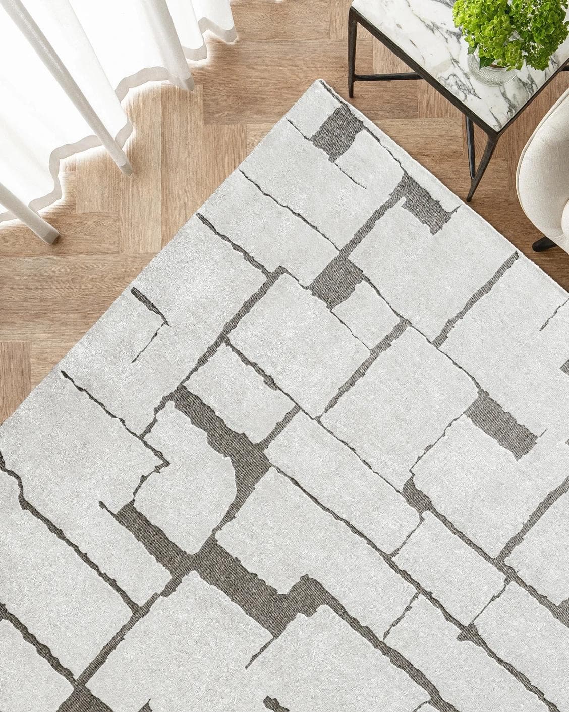 Nico Sandy carpet in ivory, grey and brown, shown in a lifestyle top view as image 2