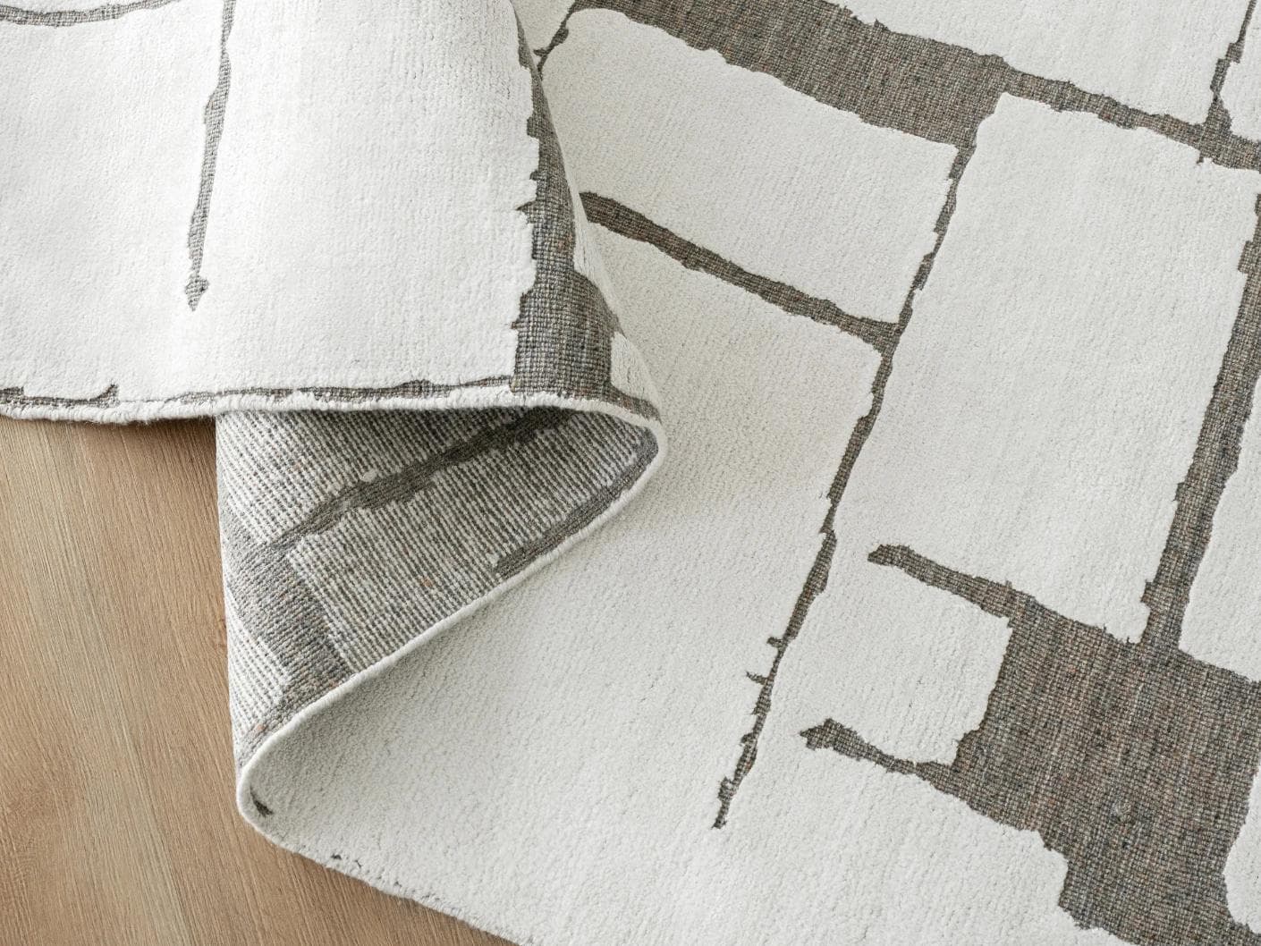 Nico Sandy carpet in ivory, grey and brown, shown in a product close-up as image 11