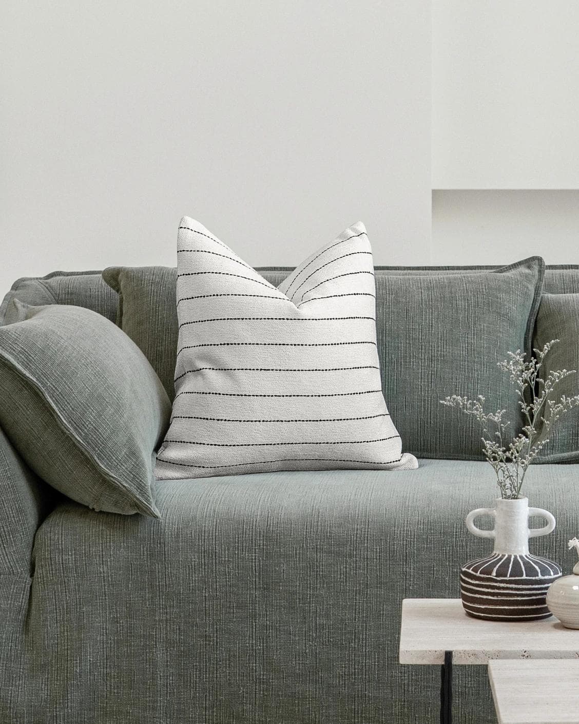 Noa Bianca cushion in black and ivory, shown in a lifestyle front view as image 4