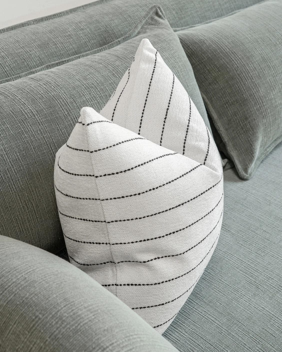 Noa Bianca cushion in black and ivory, shown in a lifestyle front view as image 5