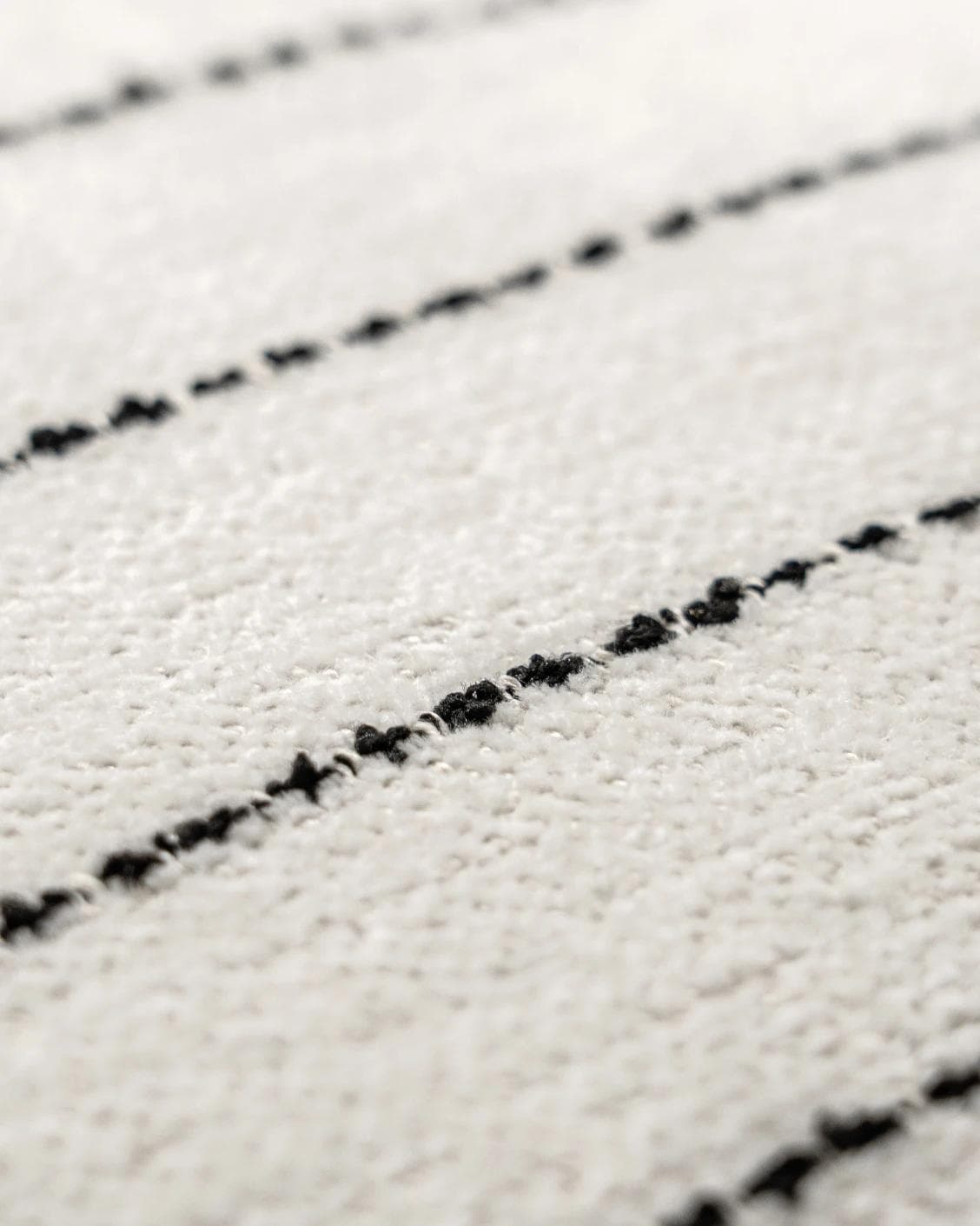 Noa Bianca cushion in black and ivory, shown in a product close-up as image 6