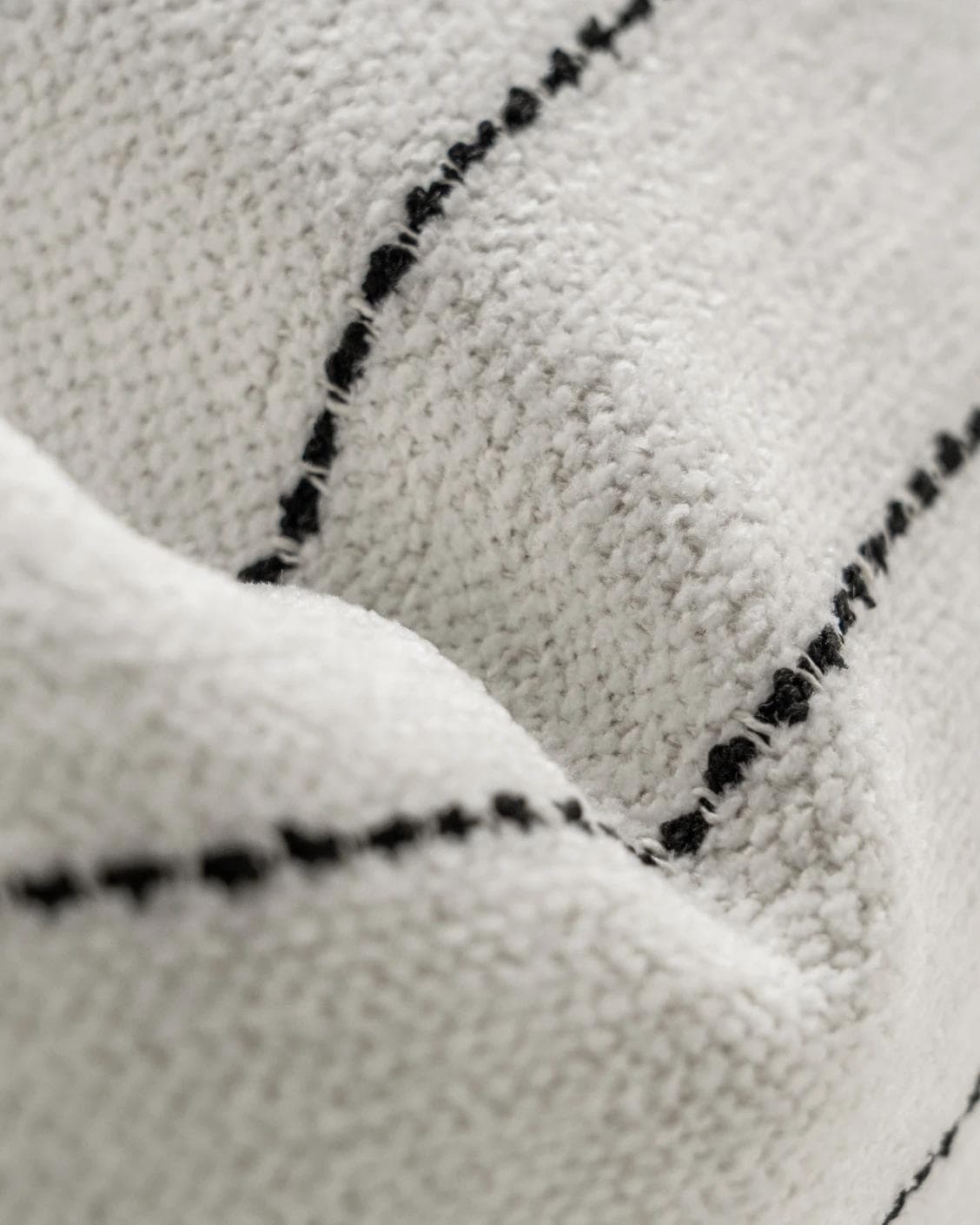 Noa Bianca cushion in black and ivory, shown in a product close-up as image 7