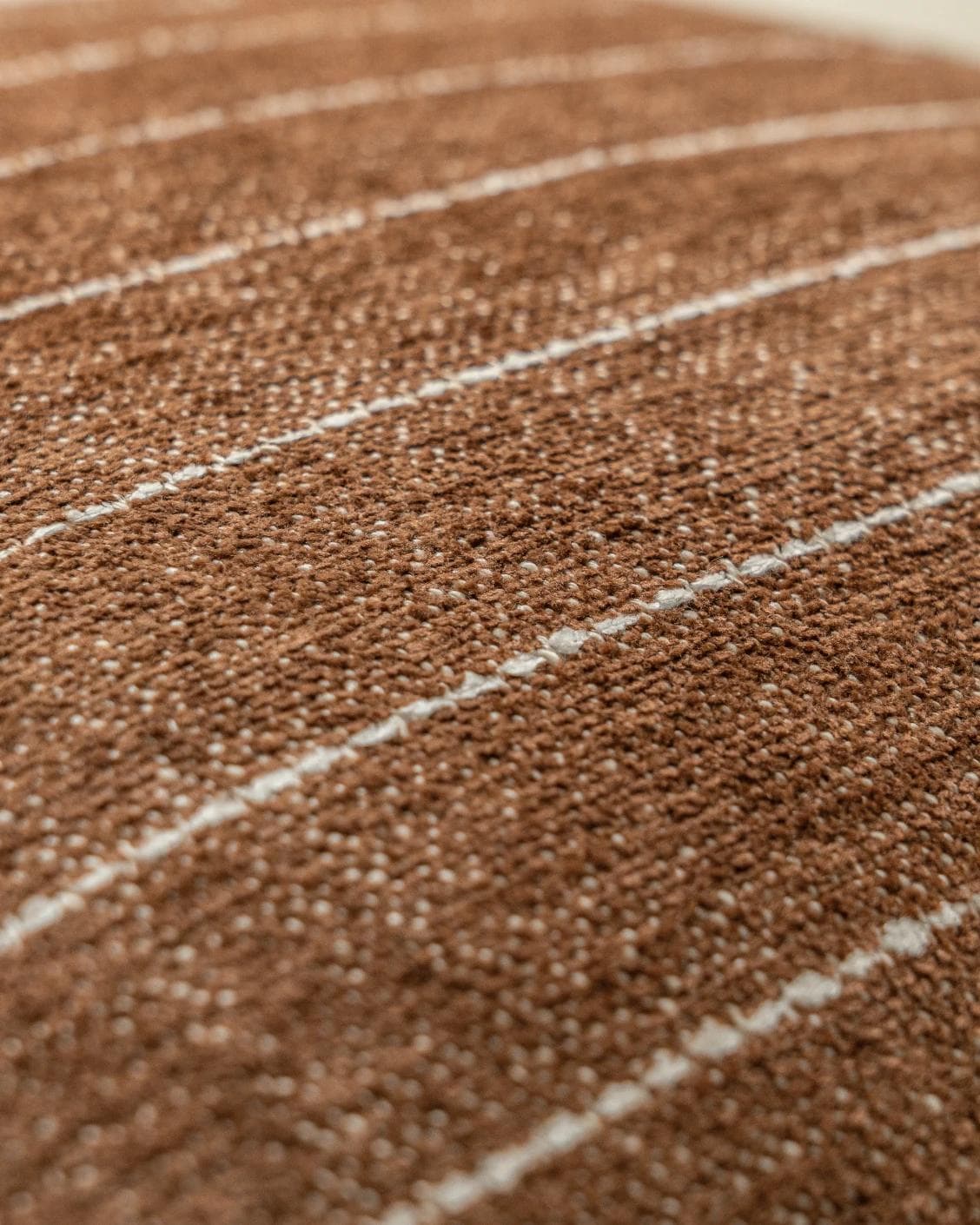 Noa Rust cushion in white and brown, shown in a product close-up as image 6