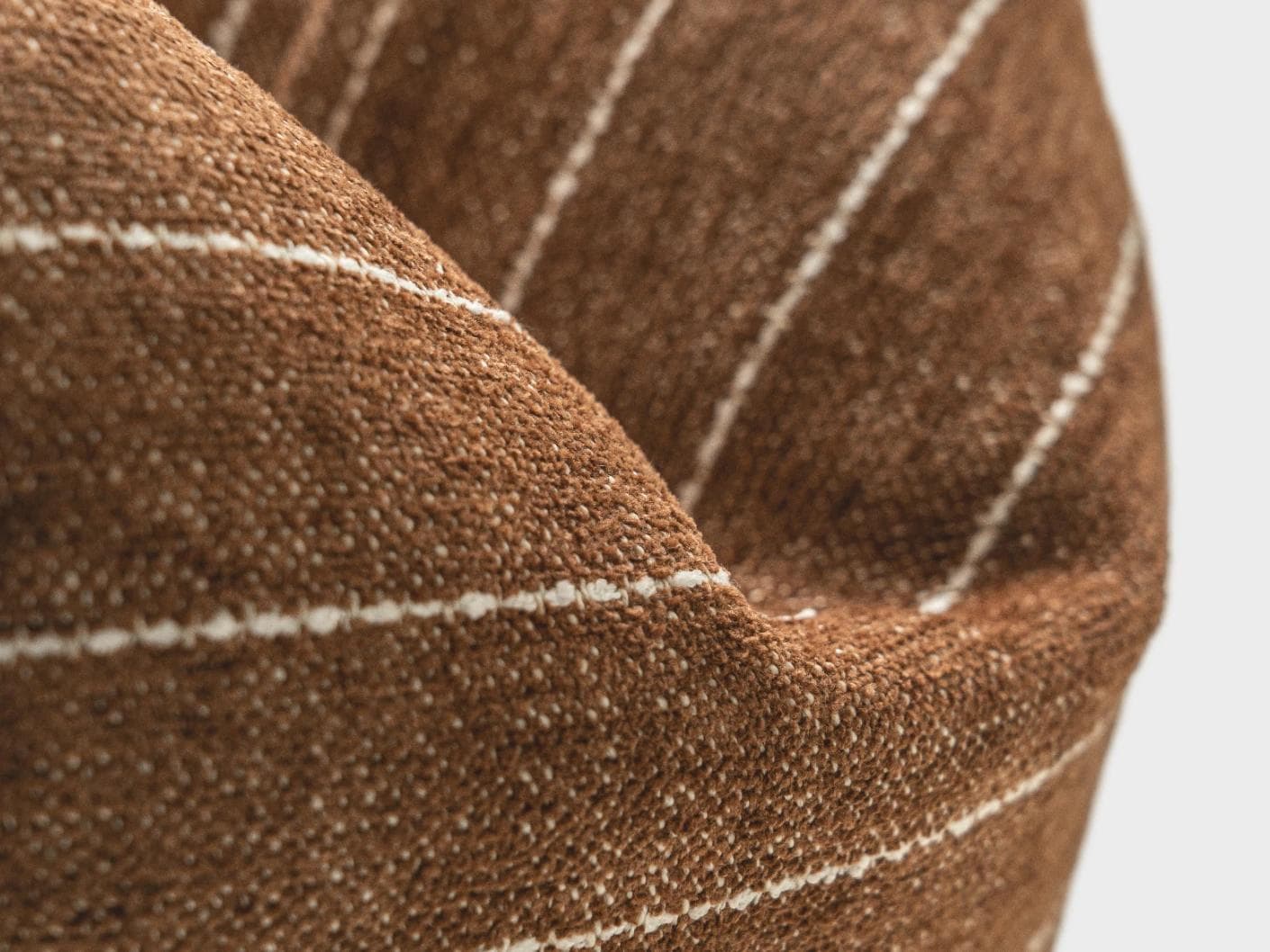 Noa Rust cushion in white and brown, shown in a product close-up as image 7