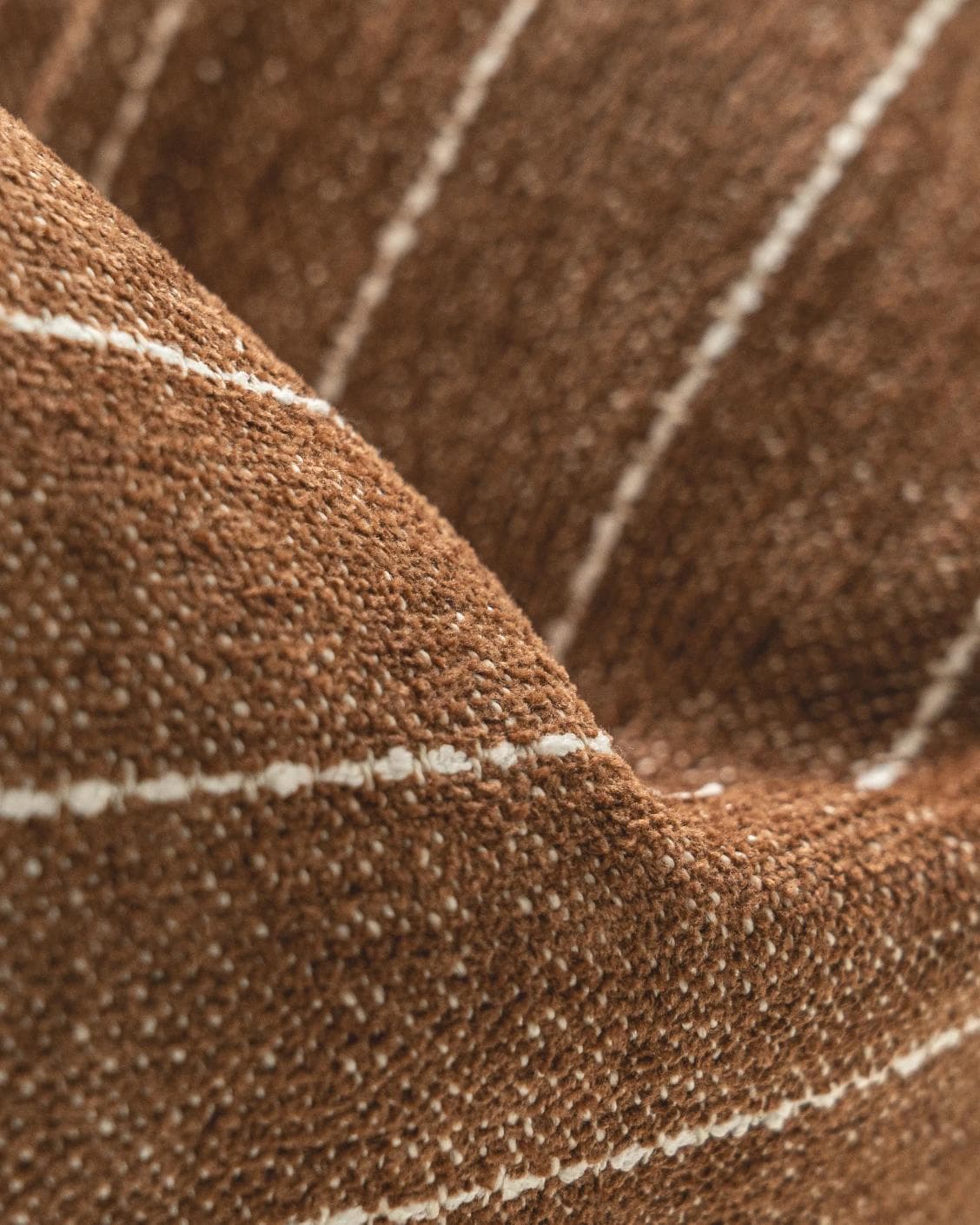 Noa Rust cushion in white and brown, shown in a product close-up as image 7