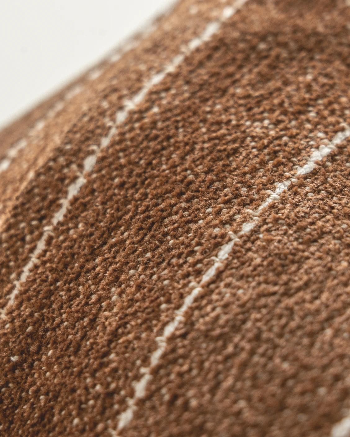 Noa Rust cushion in white and brown, shown in a product close-up as image 8