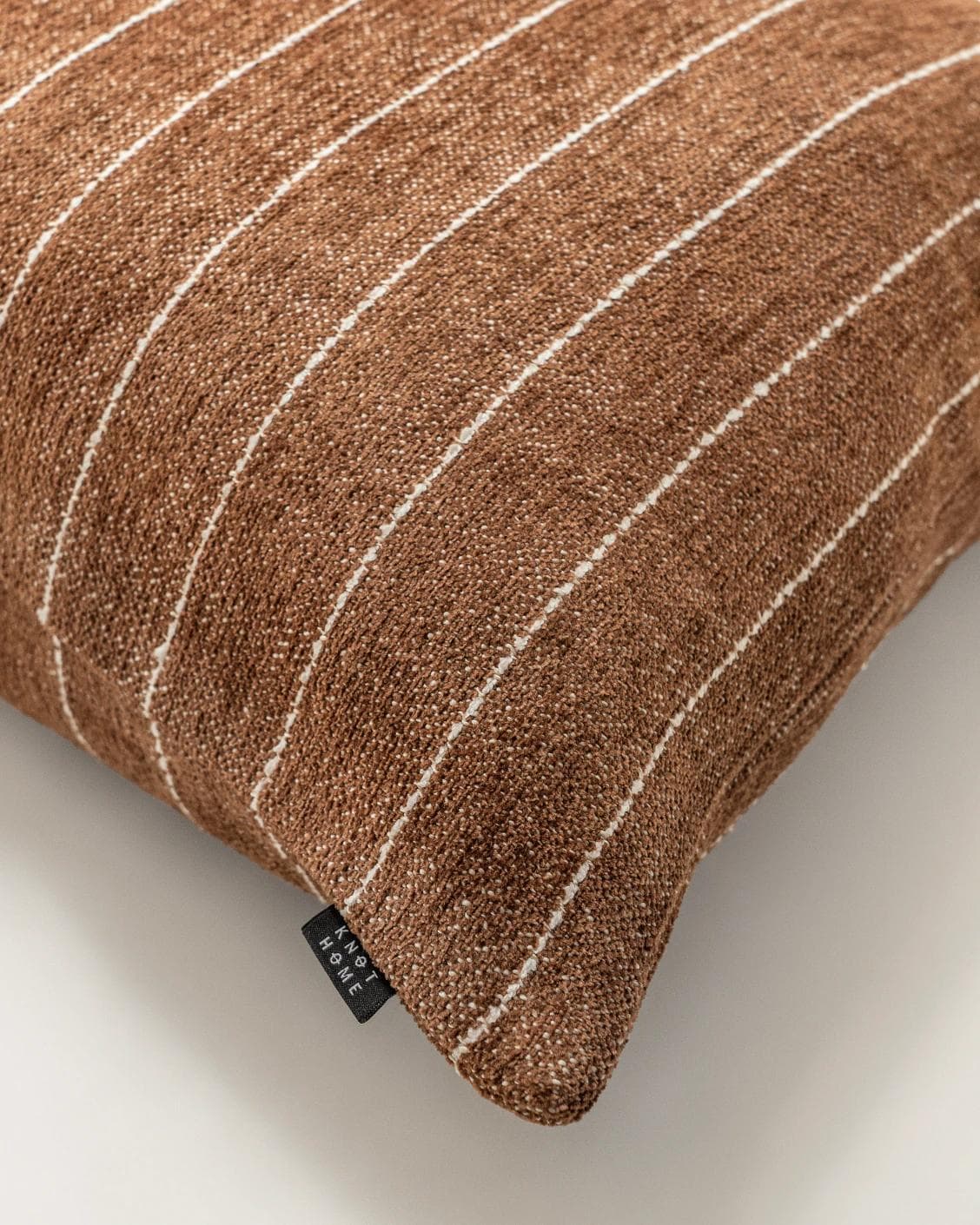 Noa Rust cushion in white and brown, shown in a product top view as image 10
