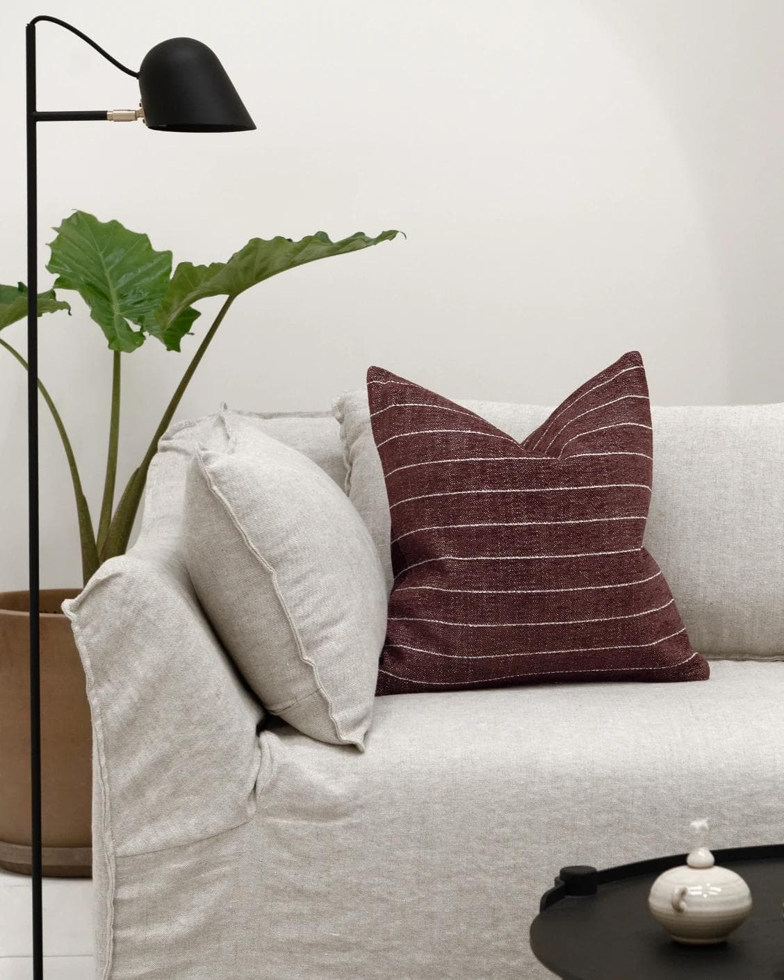 Noa Scarlet cushion in white and red, shown in a lifestyle front view as image 4
