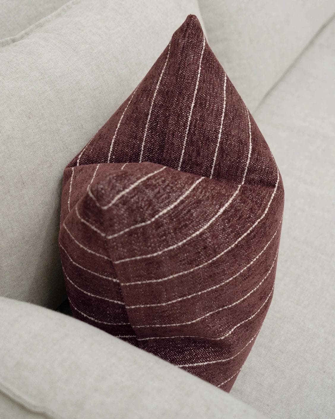 Noa Scarlet cushion in white and red, shown in a lifestyle top view as image 5
