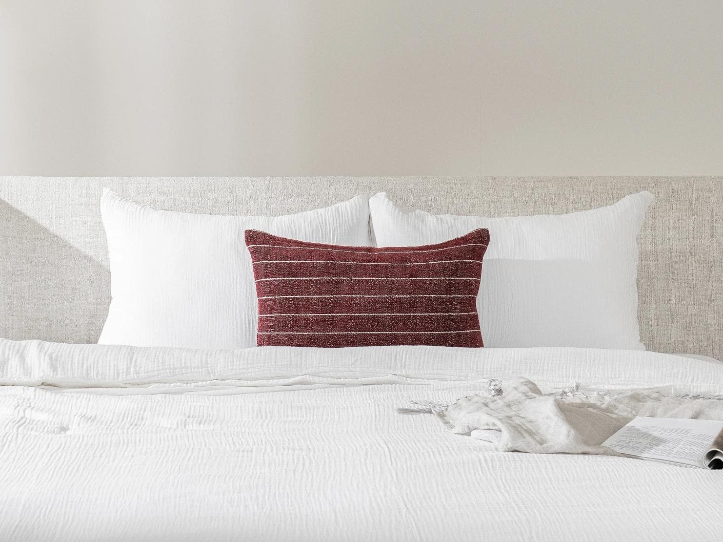 Noa Scarlet III cushion in burgundy, shown in a lifestyle front view as image 2