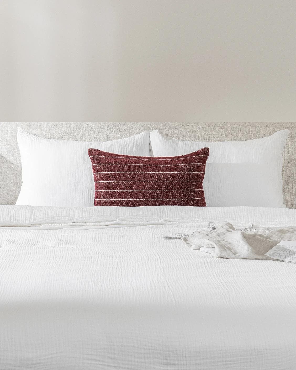 Noa Scarlet III cushion in burgundy, shown in a lifestyle front view as image 2