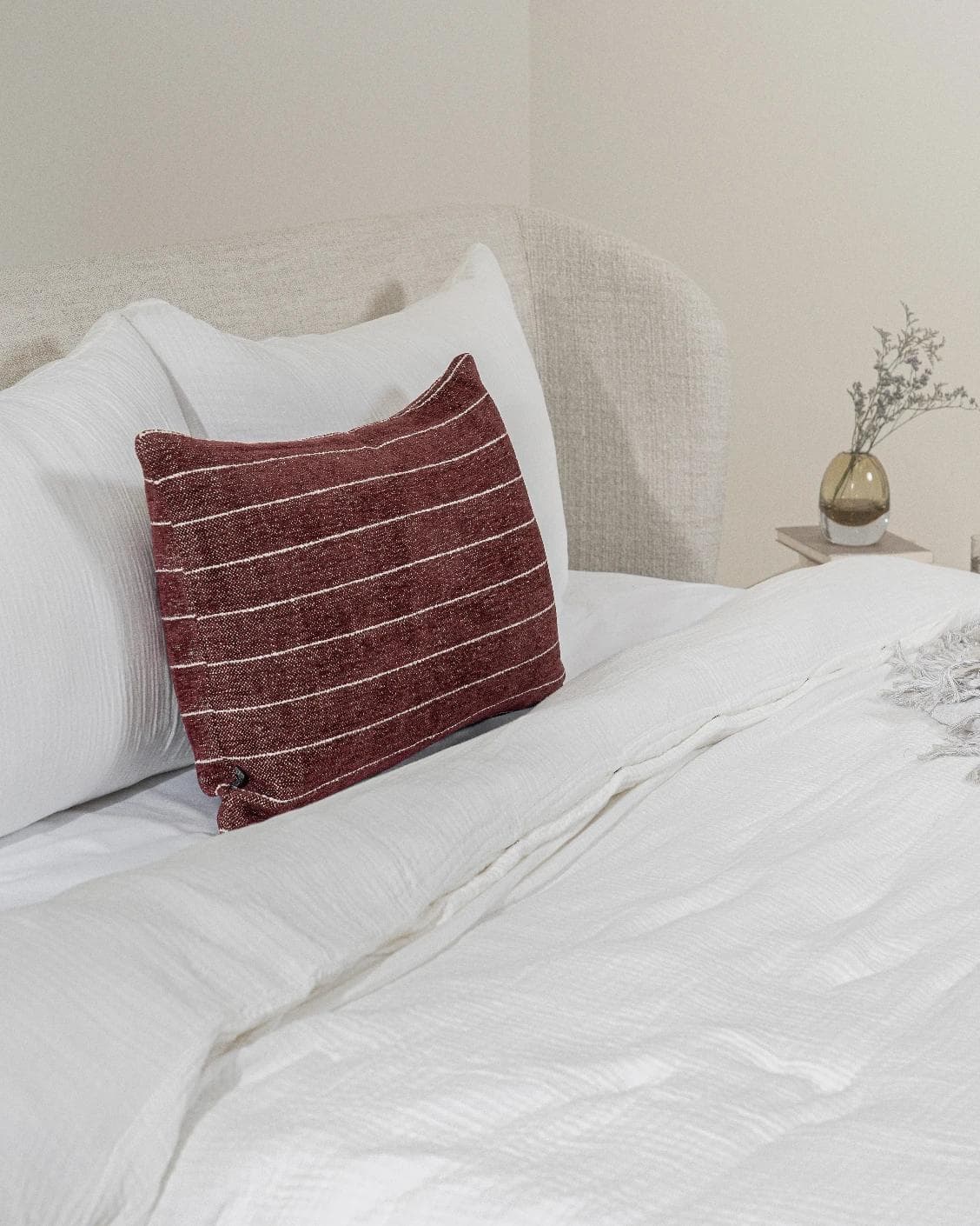Noa Scarlet III cushion in burgundy, shown in a lifestyle left view as image 4